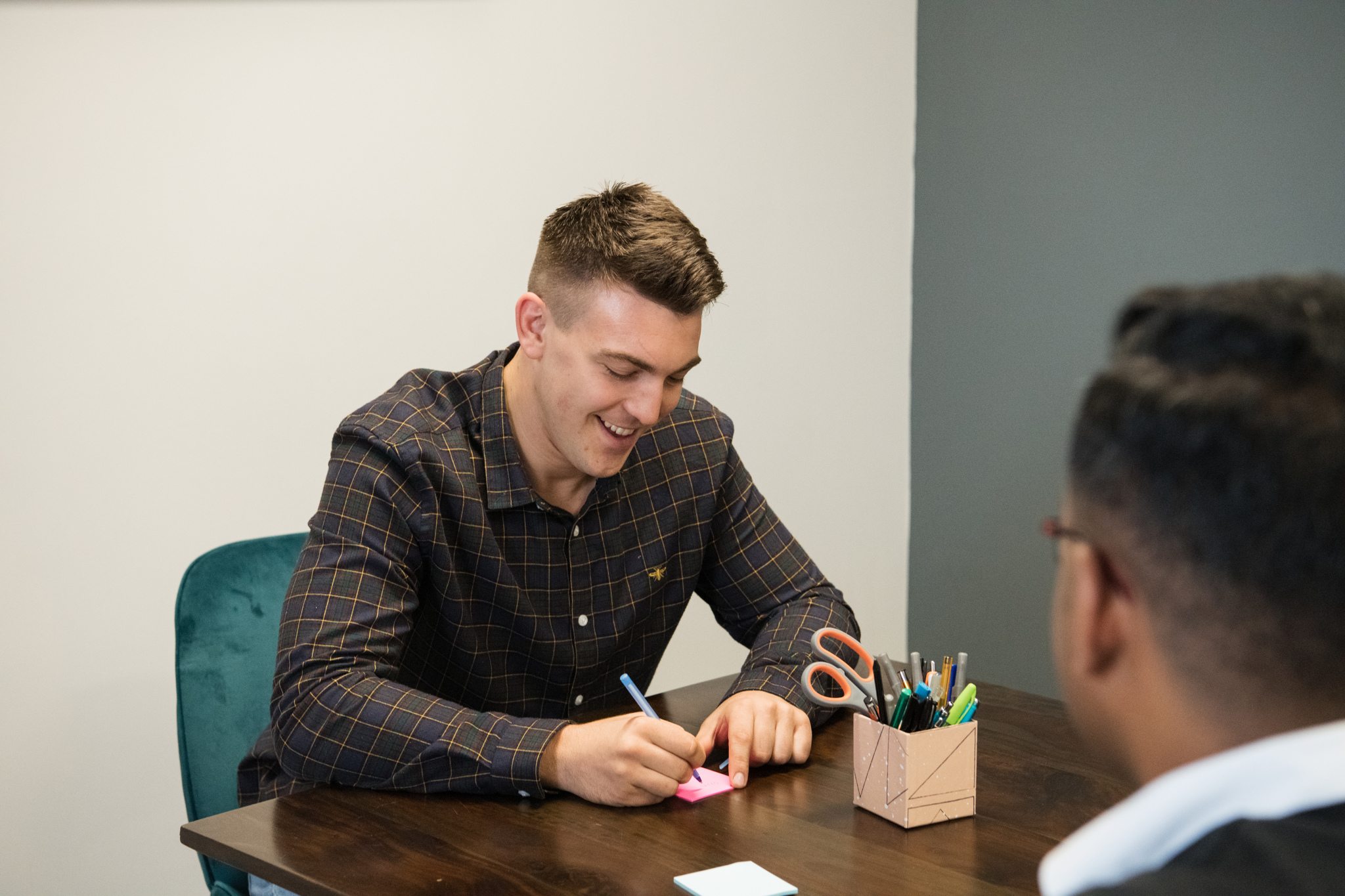"Collaborative meeting in 1899 Suite with colorful sticky notes for event planning."