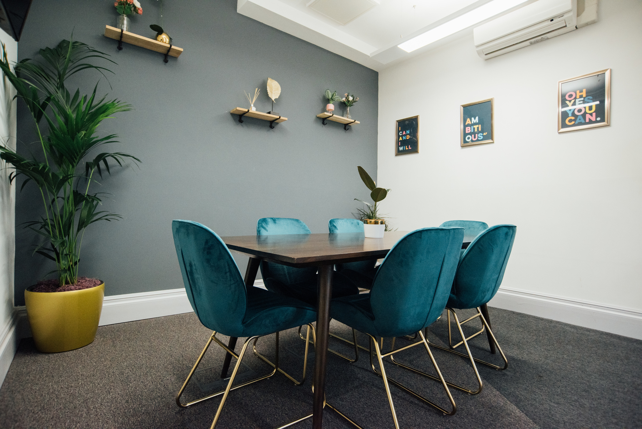 Modern meeting room in Wizu Workspace with teal chairs, perfect for collaboration events.
