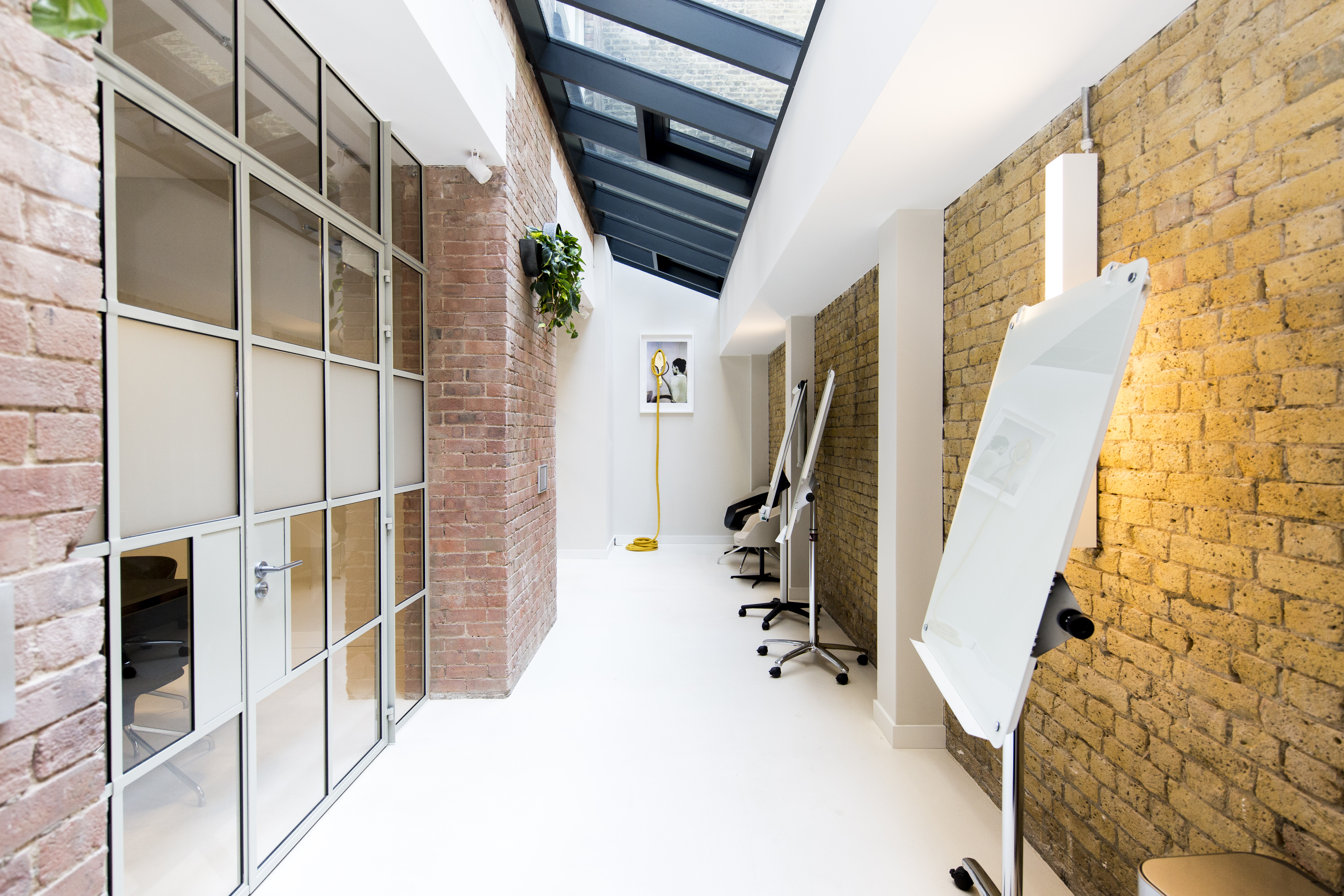 Industrial-chic breakout room with exposed brick for workshops and agile collaboration.