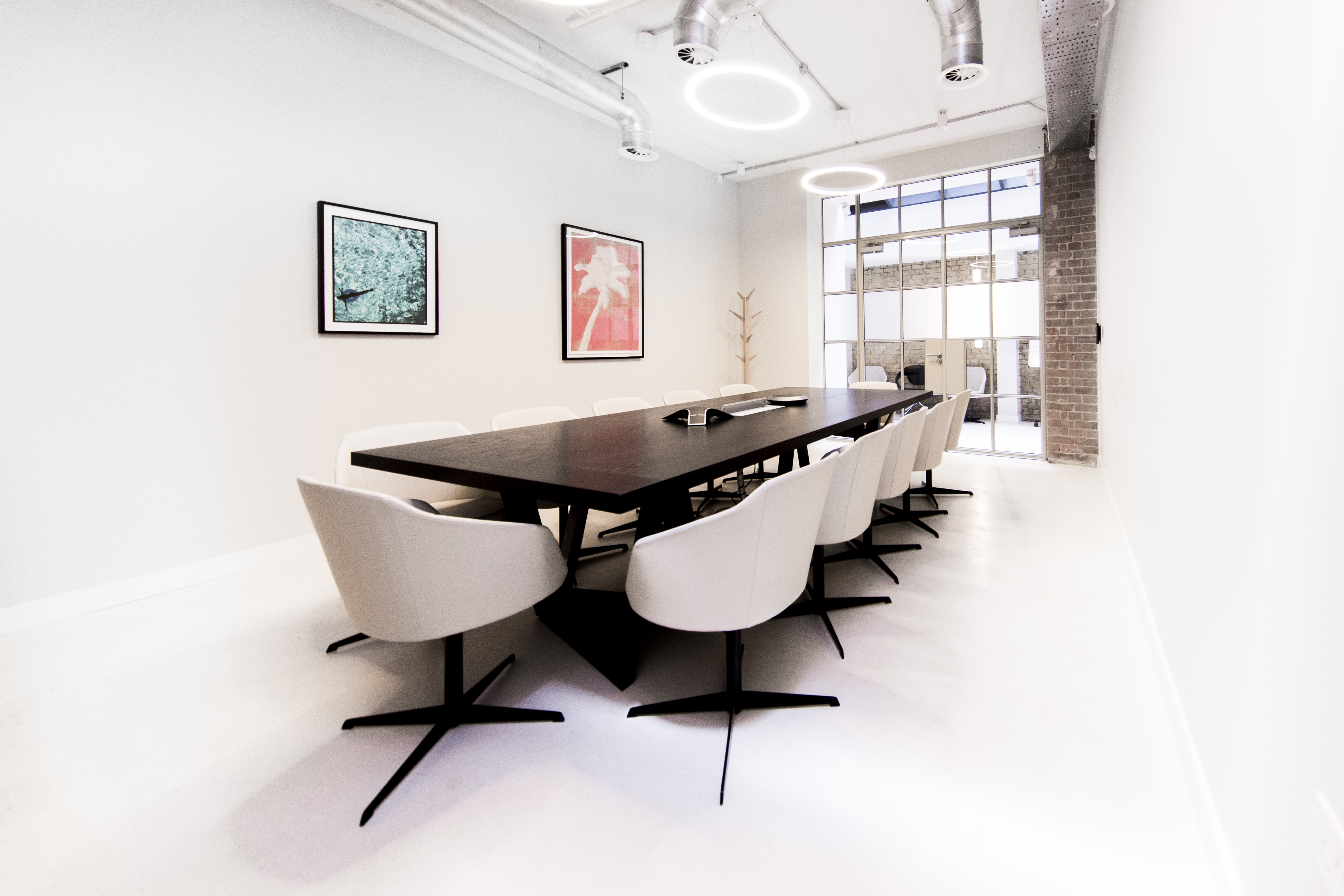 Minimalist boardroom in Fora Clerkenwell with large table for strategy sessions and board meetings.