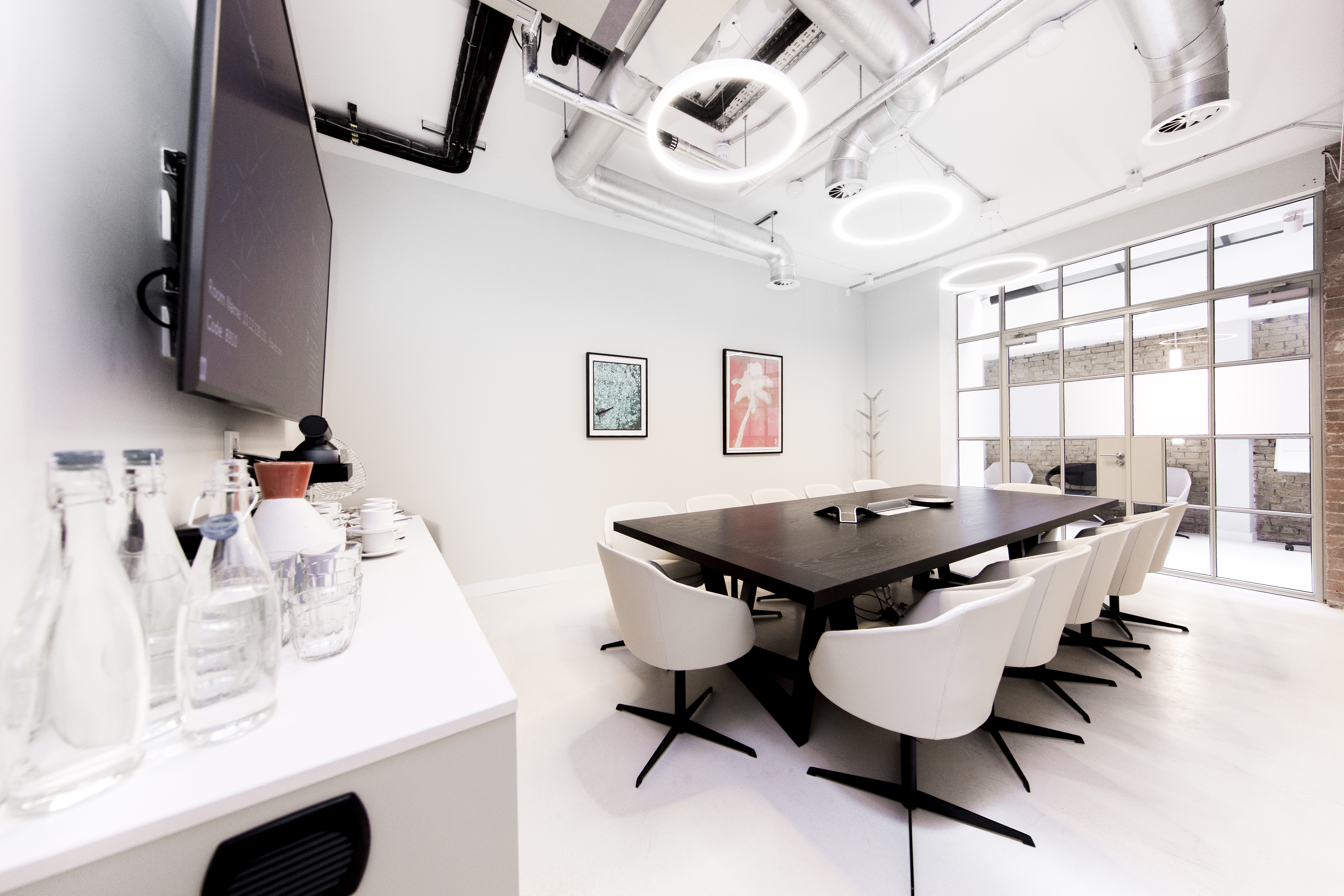 Industrial-chic boardroom with integrated tech for professional meetings and corporate events.