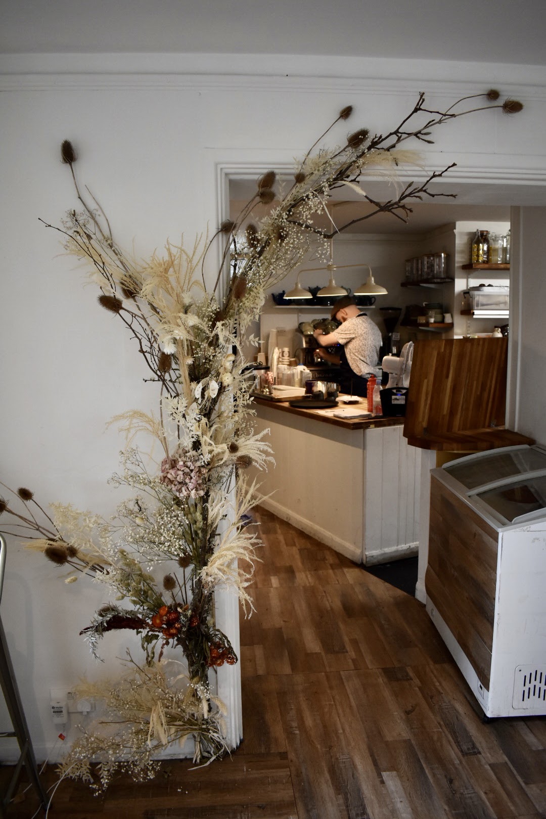 Cozy café venue with natural decor, perfect for meetings and networking events.