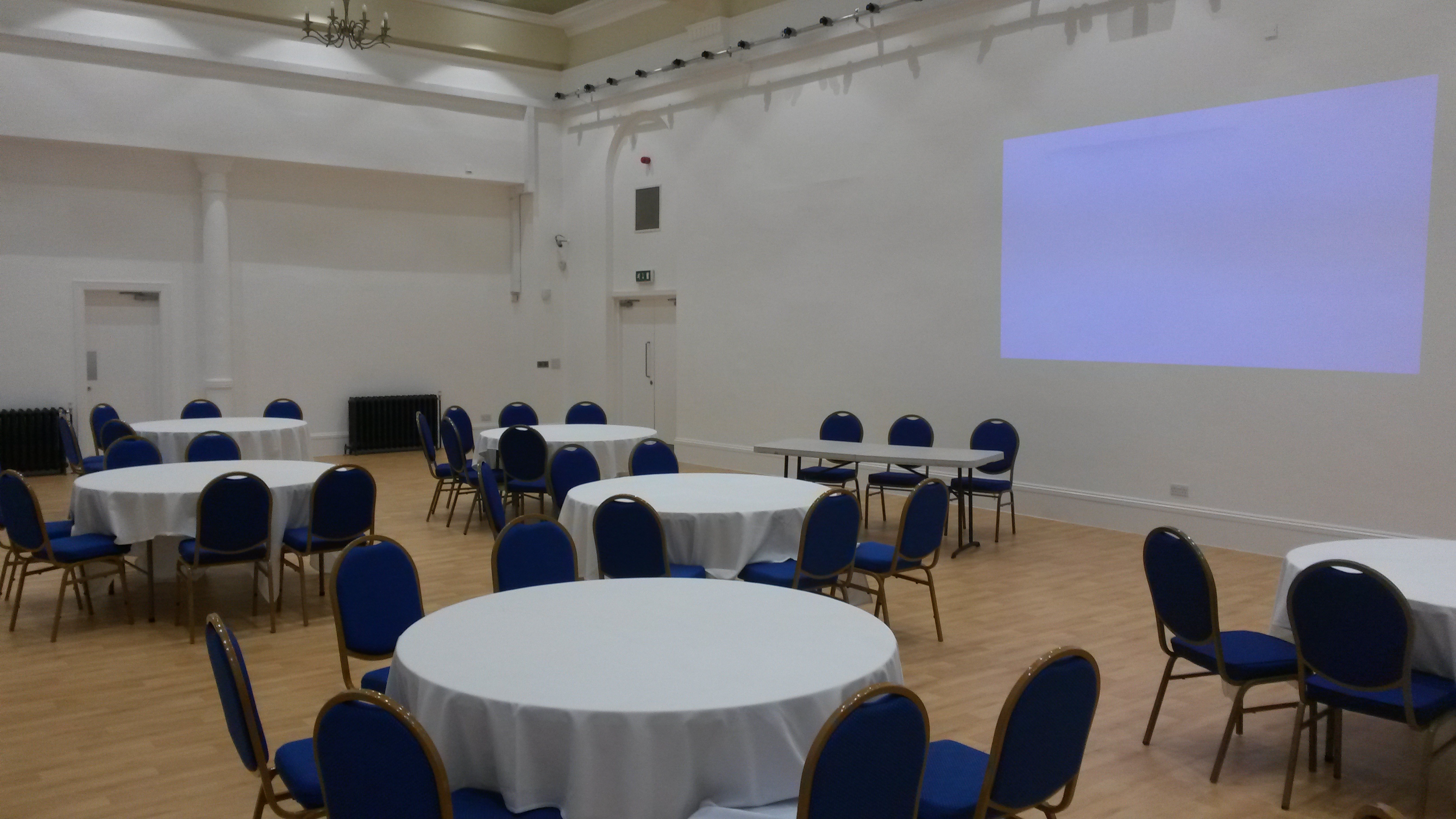 Indus Hall at Kala Sangam: versatile event space with round tables, ideal for meetings and gatherings.