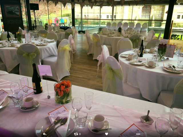Rooftop Cafe at Kala Sangam: elegant wedding venue with white linens and tulip centerpieces.