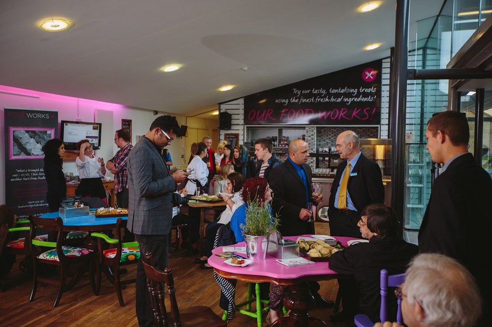 Rooftop Cafe networking event with colorful seating and refreshments in Kala Sangam Arts Centre.