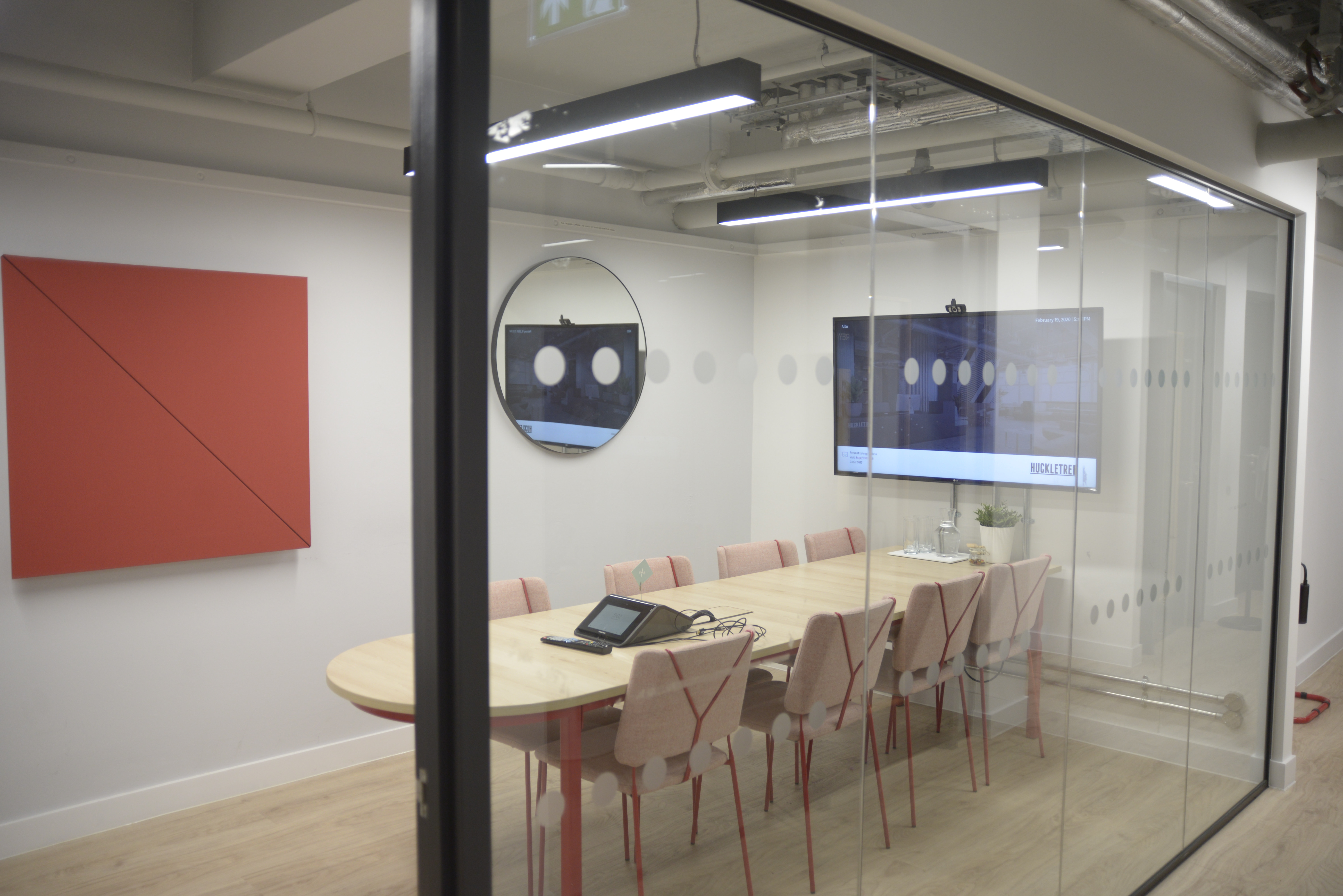 Alto Meeting Room at Huckletree Soho with oval table, ideal for meetings and brainstorming.