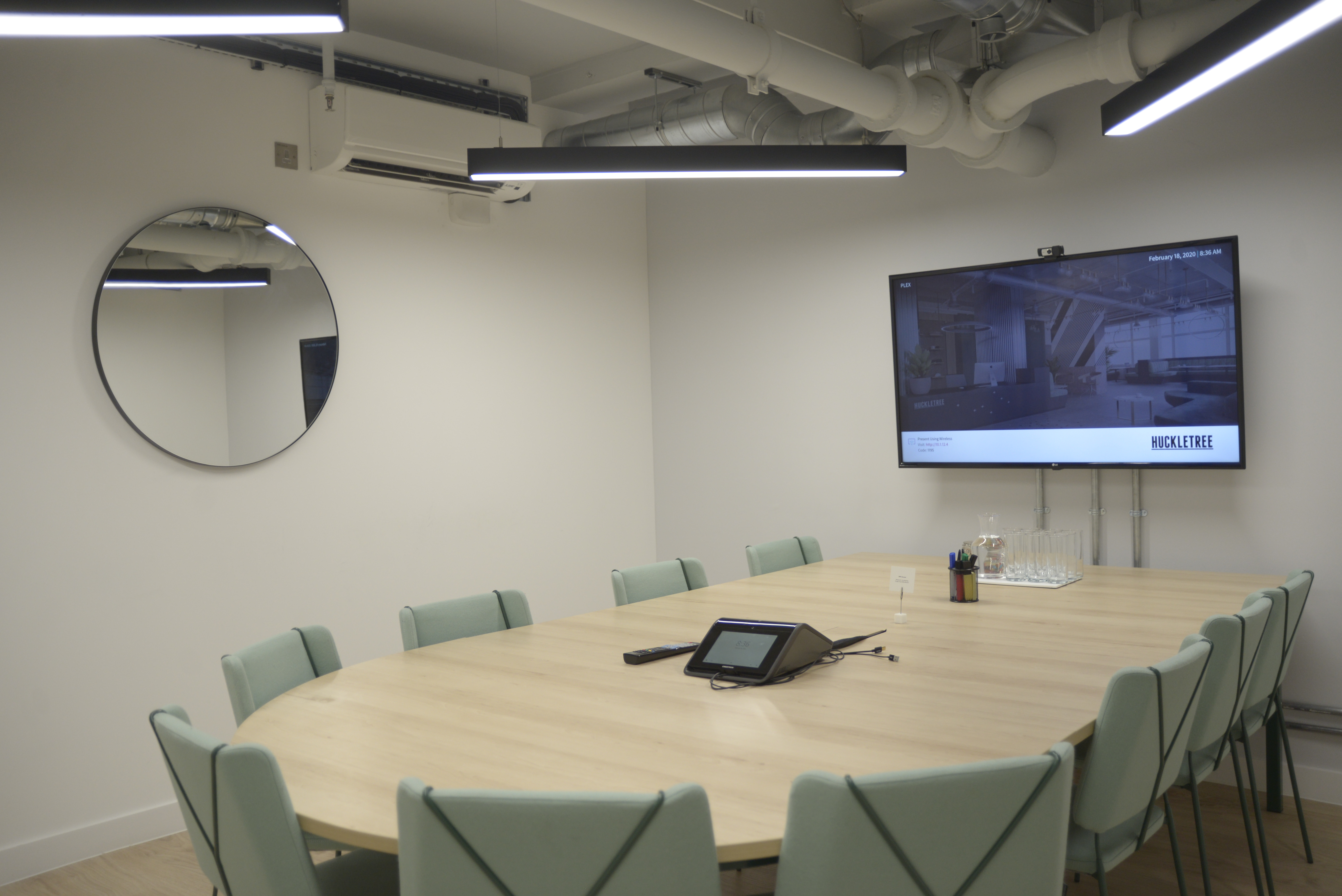 Modern Plex Meeting Room with oval table for collaborative events in Huckletree Soho.