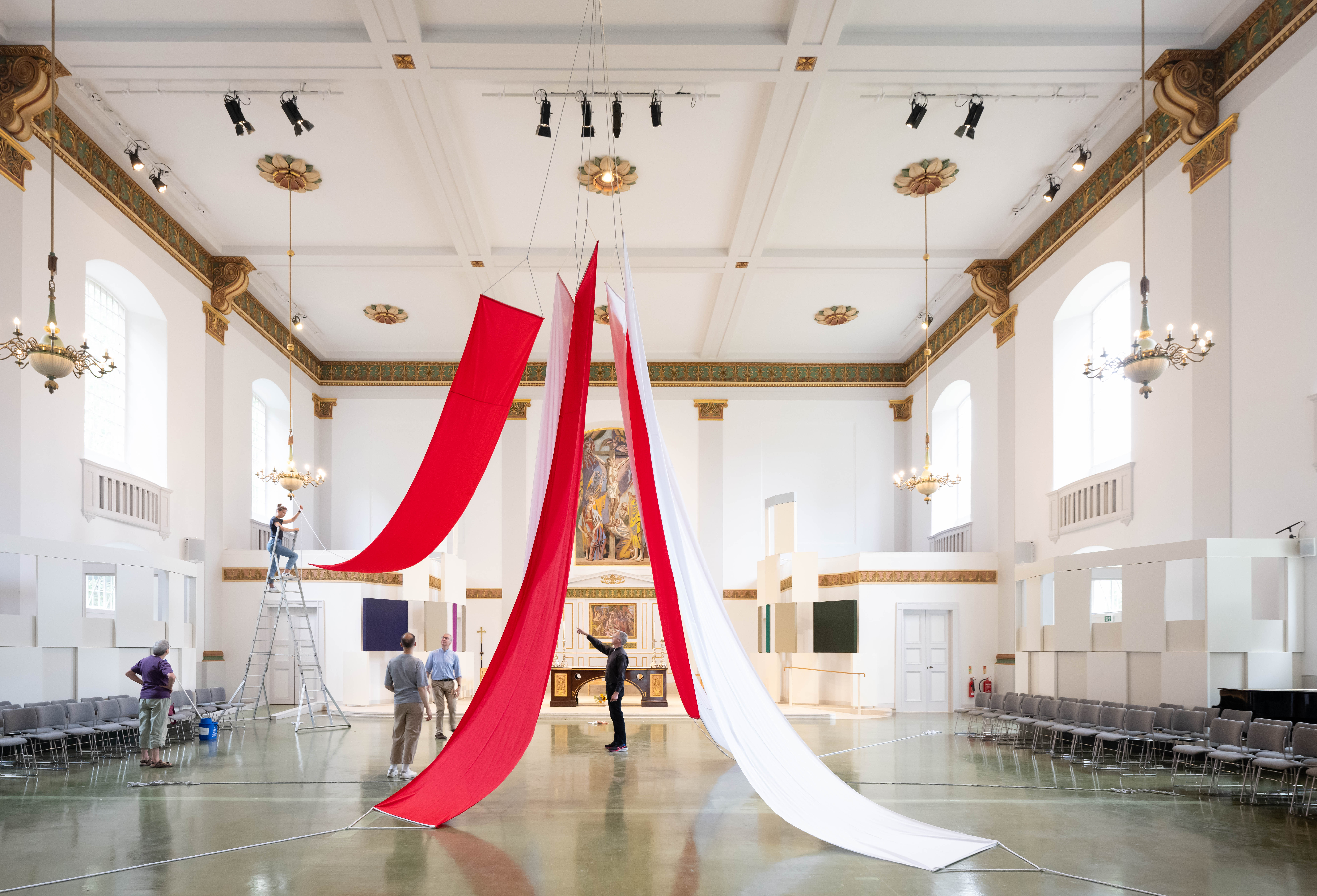 Spacious St John's Church nave with elegant decor for event planning and setup.