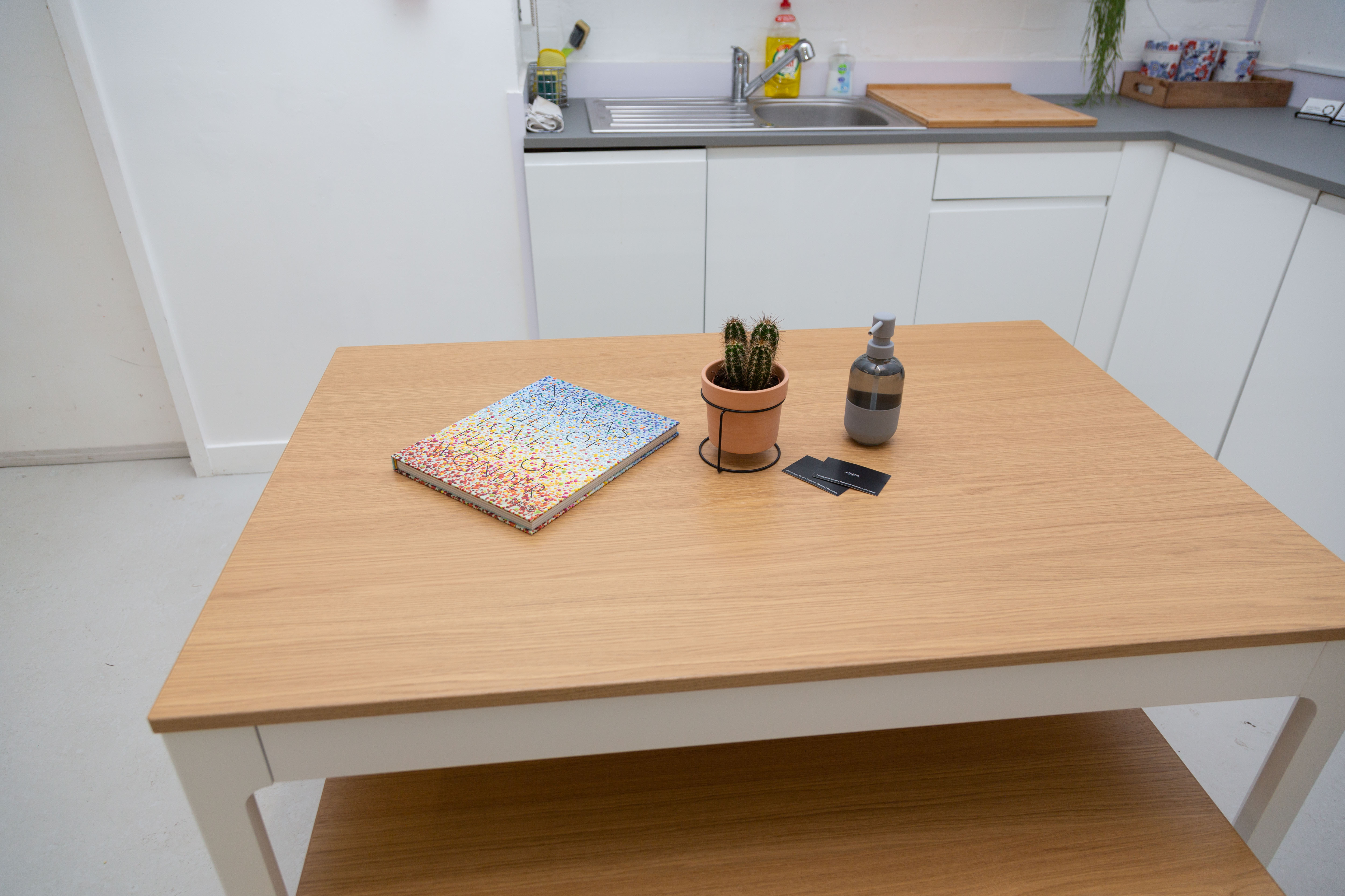 Minimalist workspace at Cove Studio, featuring a light wood table for meetings and events.