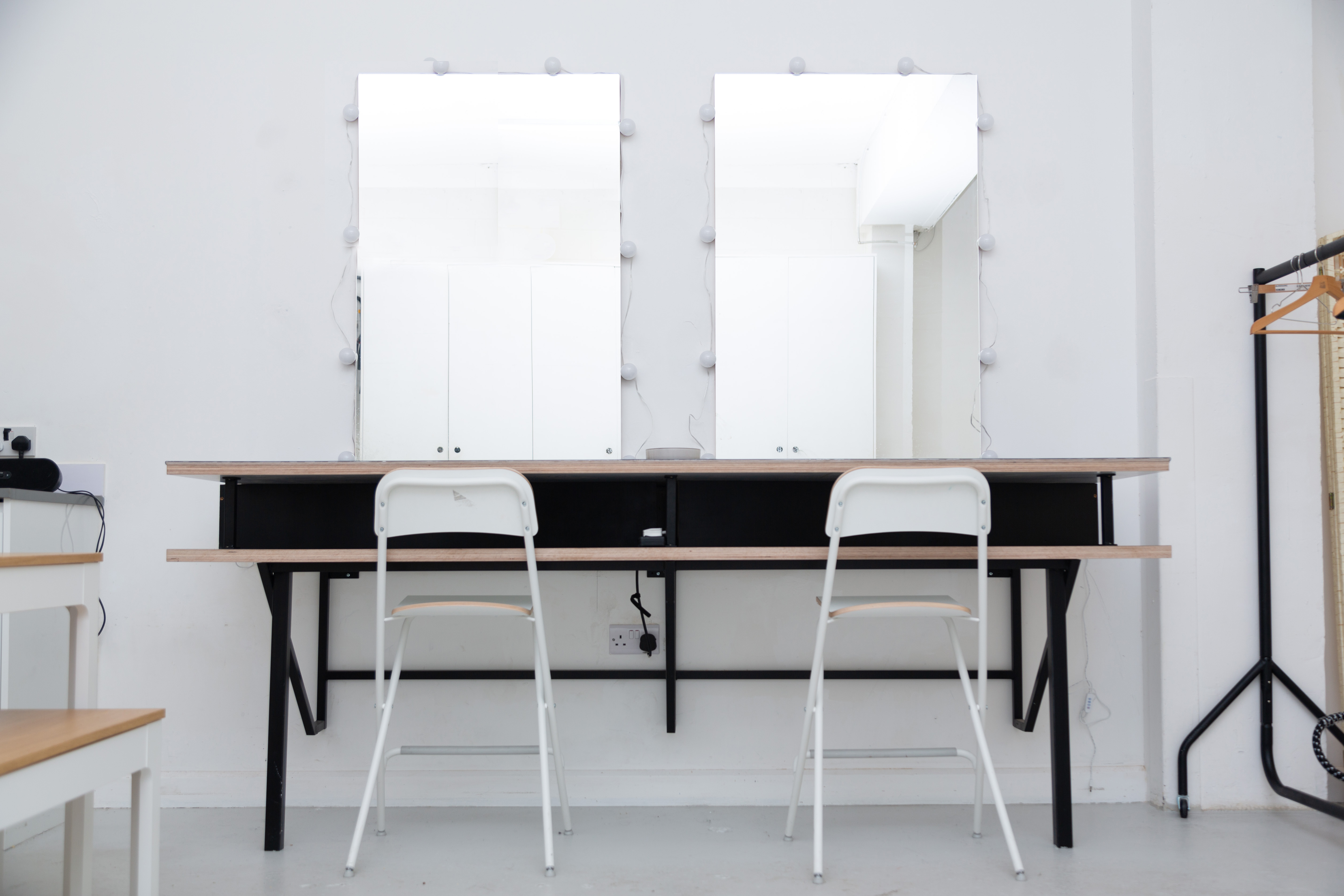 Minimalist vanity setup with dual mirrors for pre-event grooming at Cove Studio.