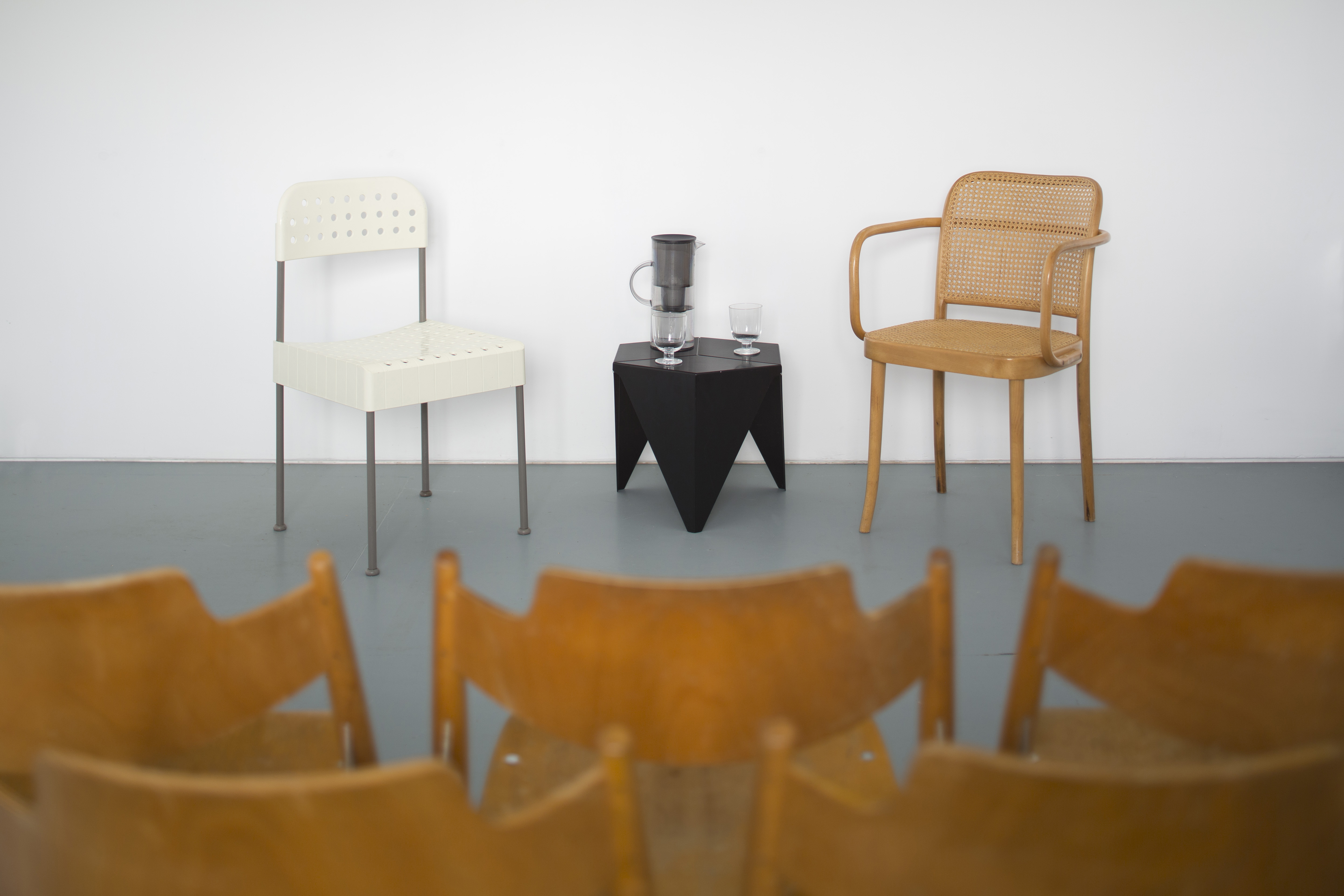 Minimalist panel discussion setup with chairs and water pitcher on Spelman Street.