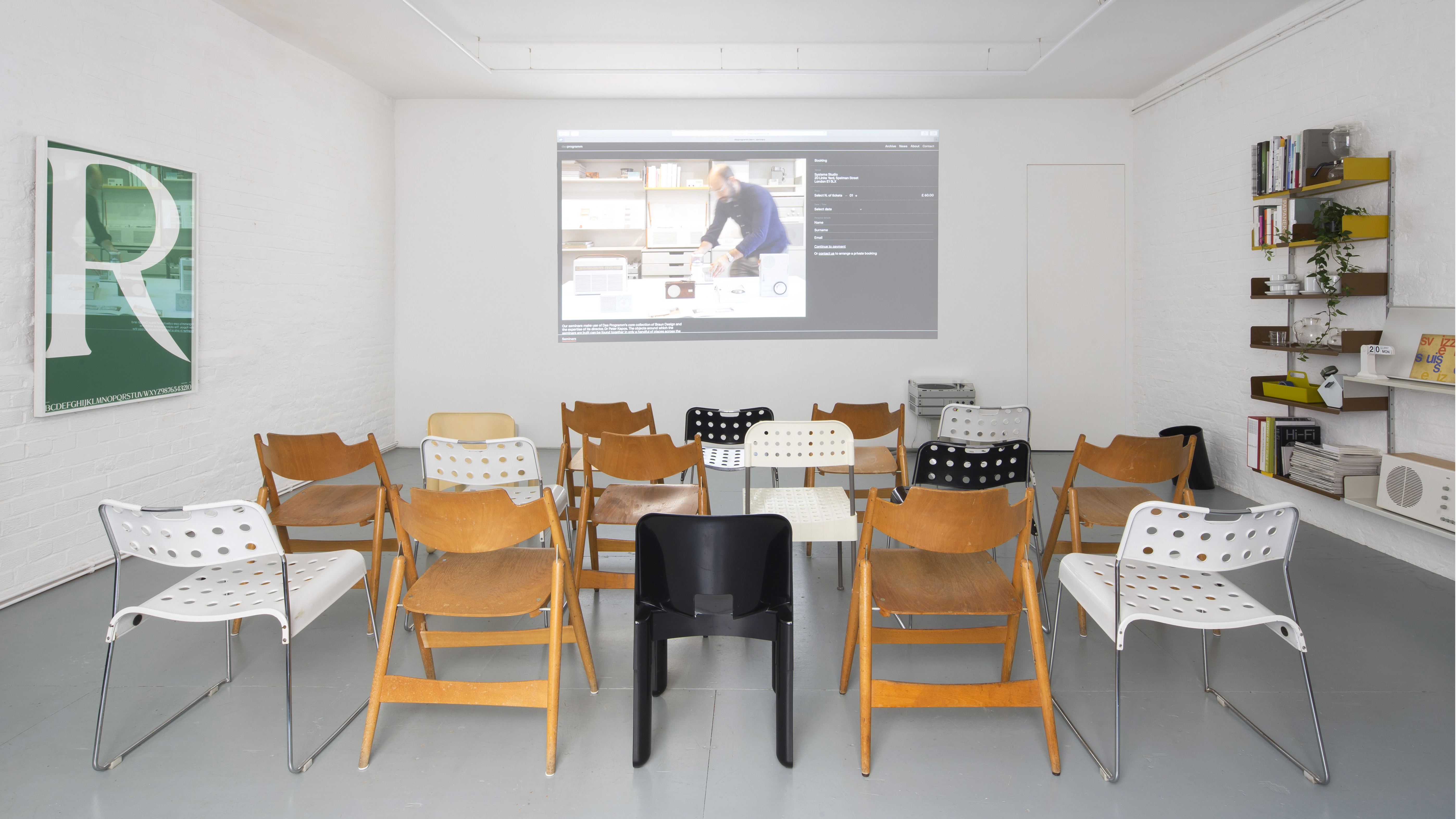 Enzo's event space with semi-circle seating and projection screen for workshops.