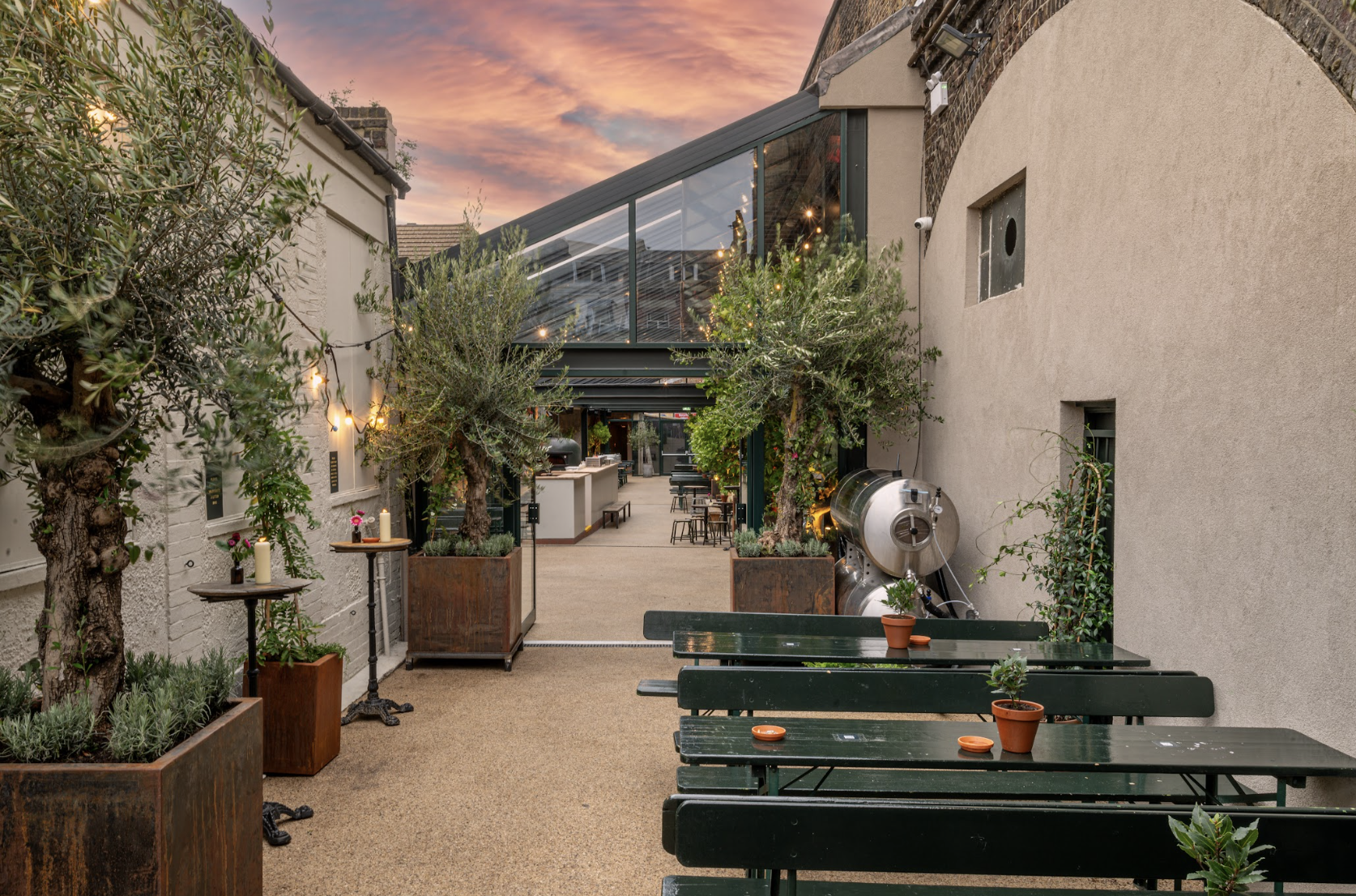 Stylish outdoor venue with greenery, ideal for receptions and casual meetings.