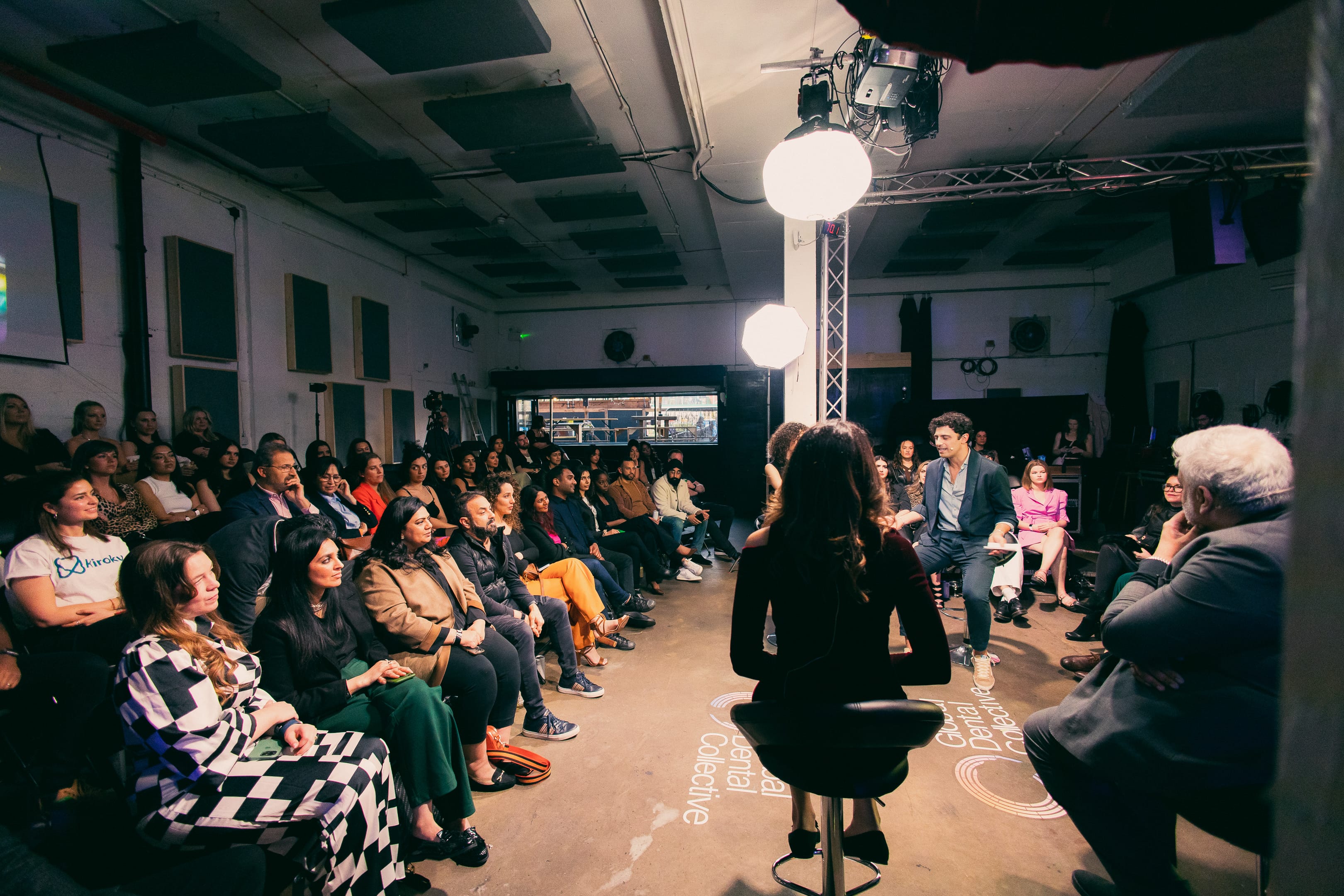 90 Live event space in Hackney Wick, panel discussion with engaged audience and dynamic lighting.