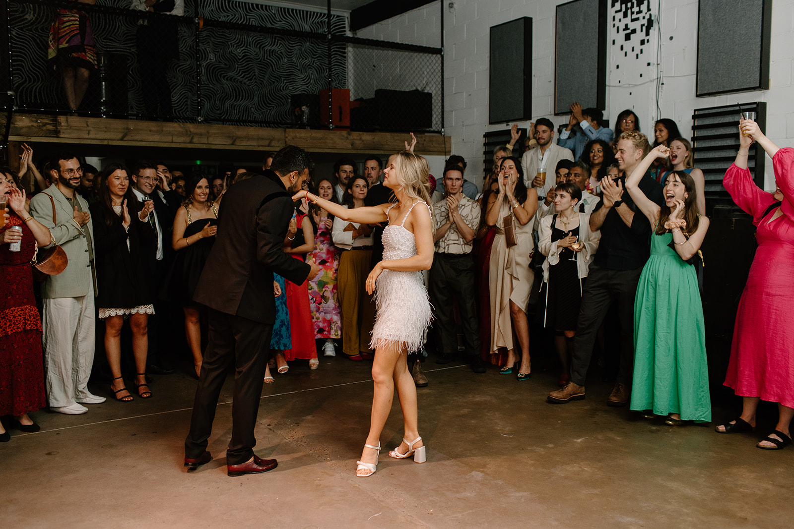 Couple dancing joyfully at a vibrant wedding celebration in No90 Hackney Wick.