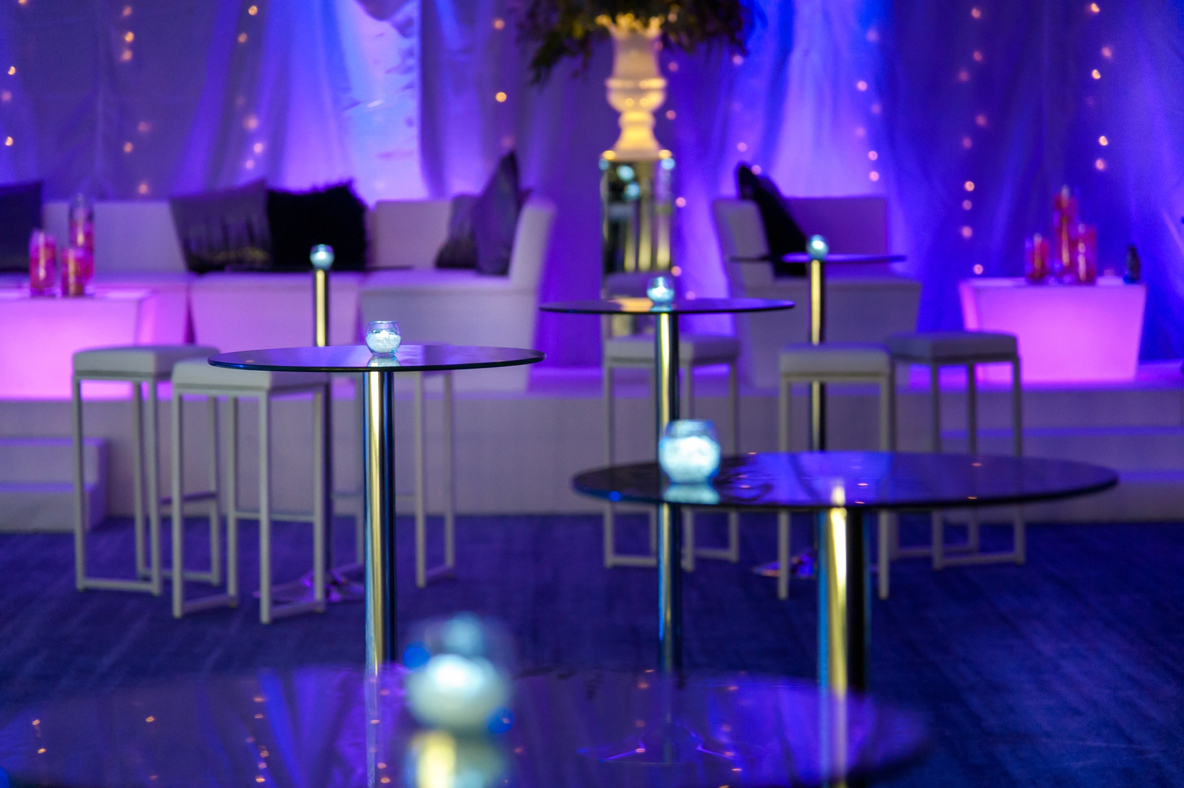 Stylish event space in Tower AB, Hilton London, with modern furniture and purple lighting.