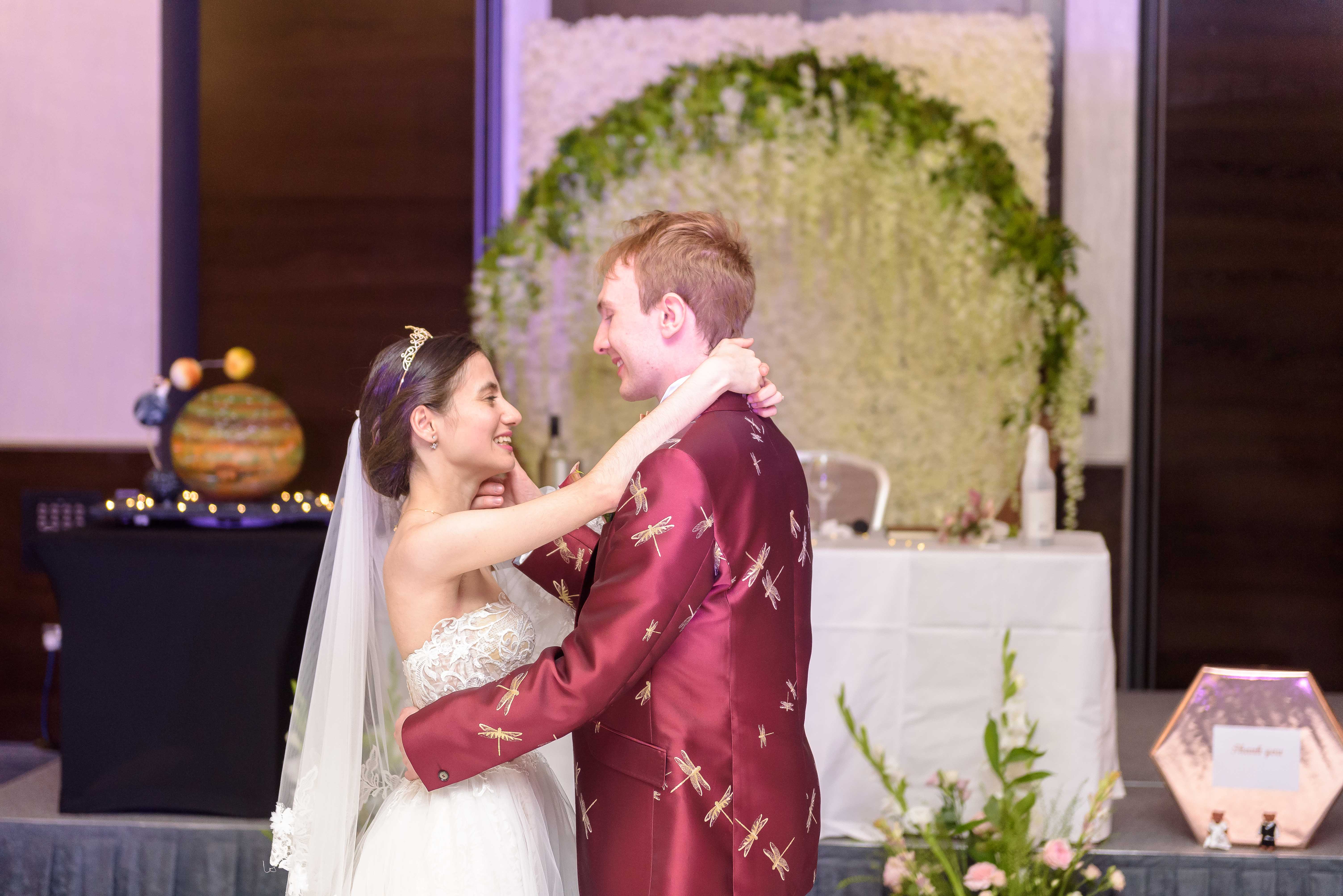 Joyful couple at wedding reception in Hilton London Tower Bridge with elegant decor.