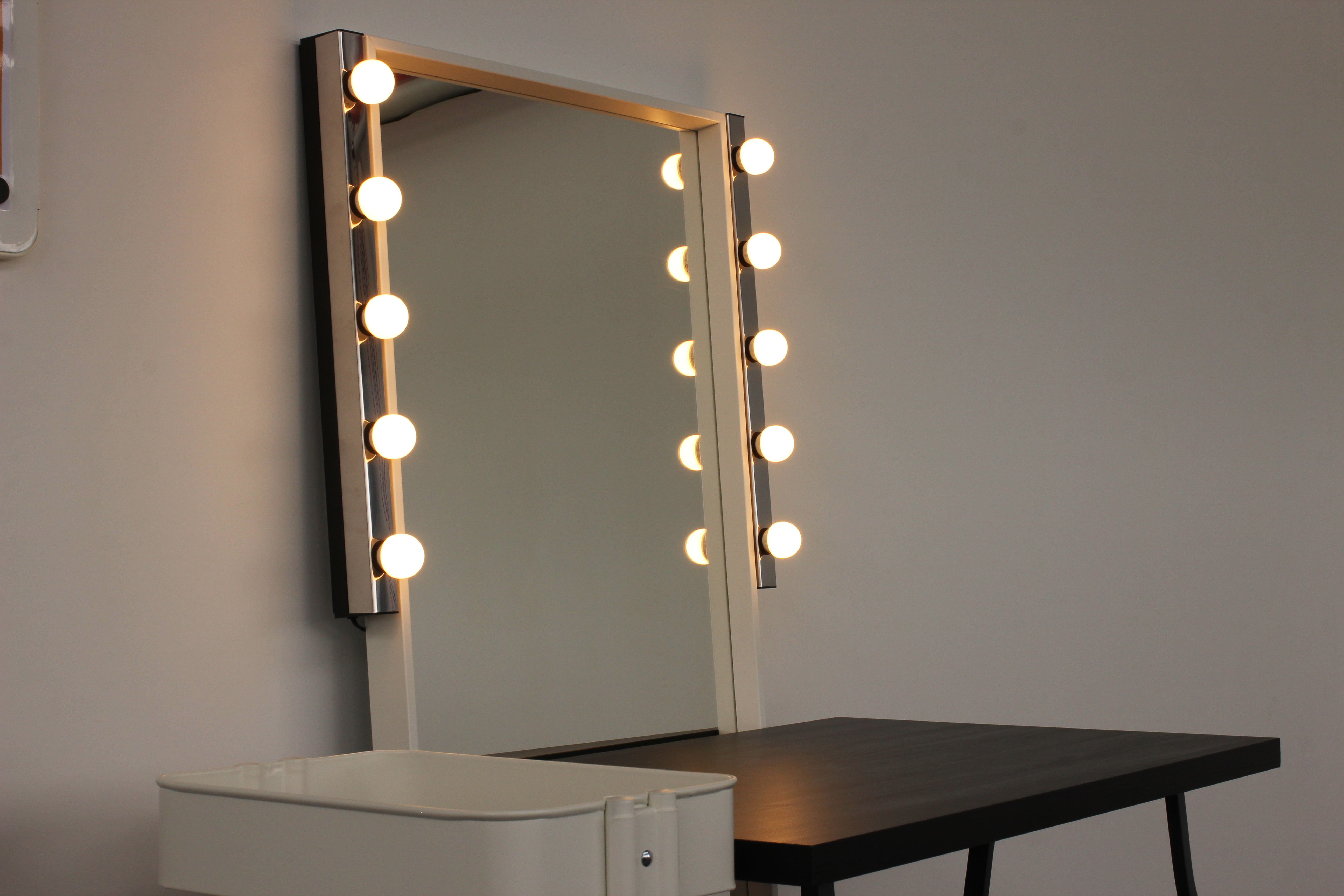 Well-lit vanity mirror in Aseptic Studios for event preparations and grooming.