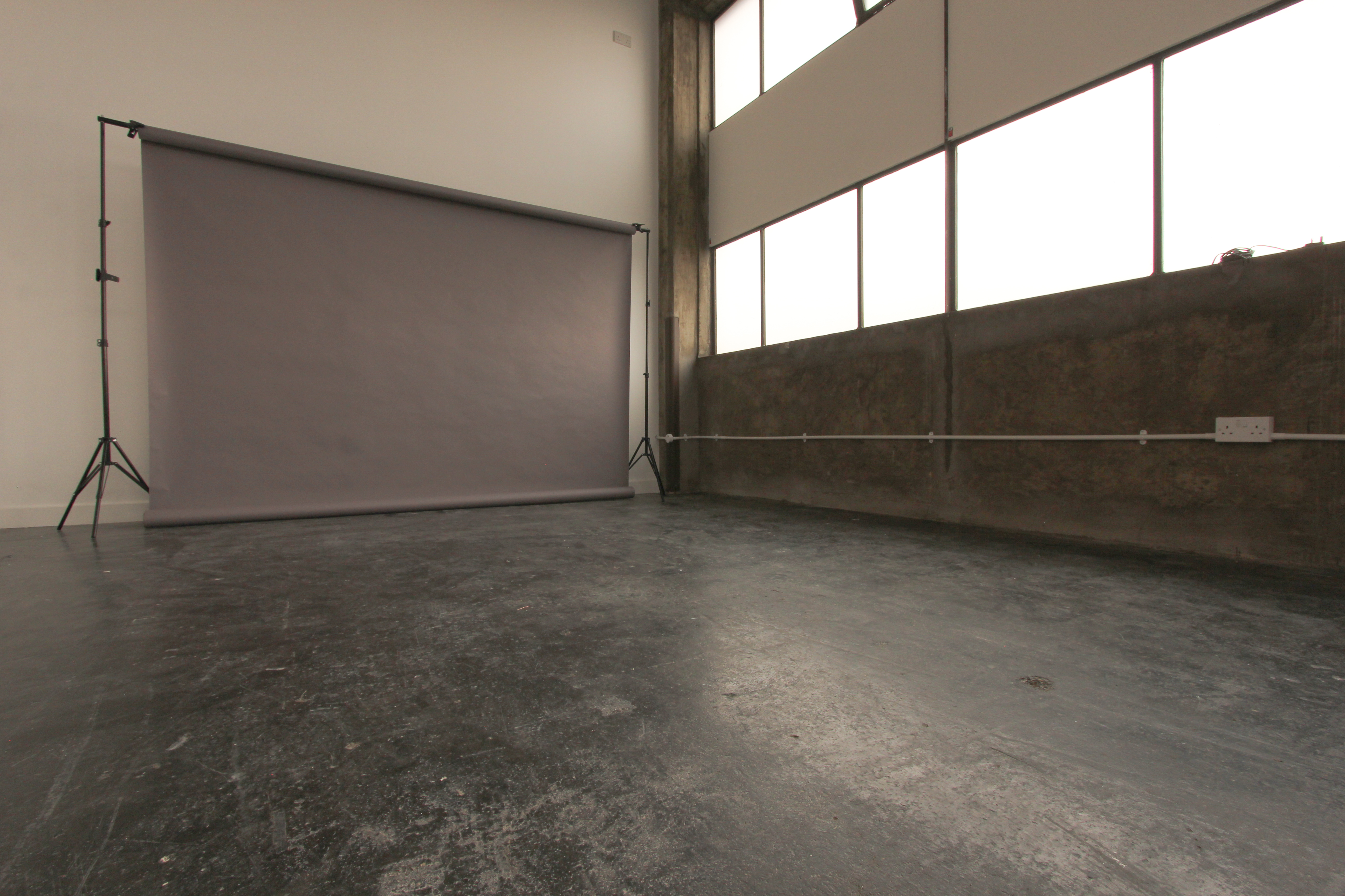 Versatile event space in Aseptic Studios with natural light, ideal for workshops and photoshoots.