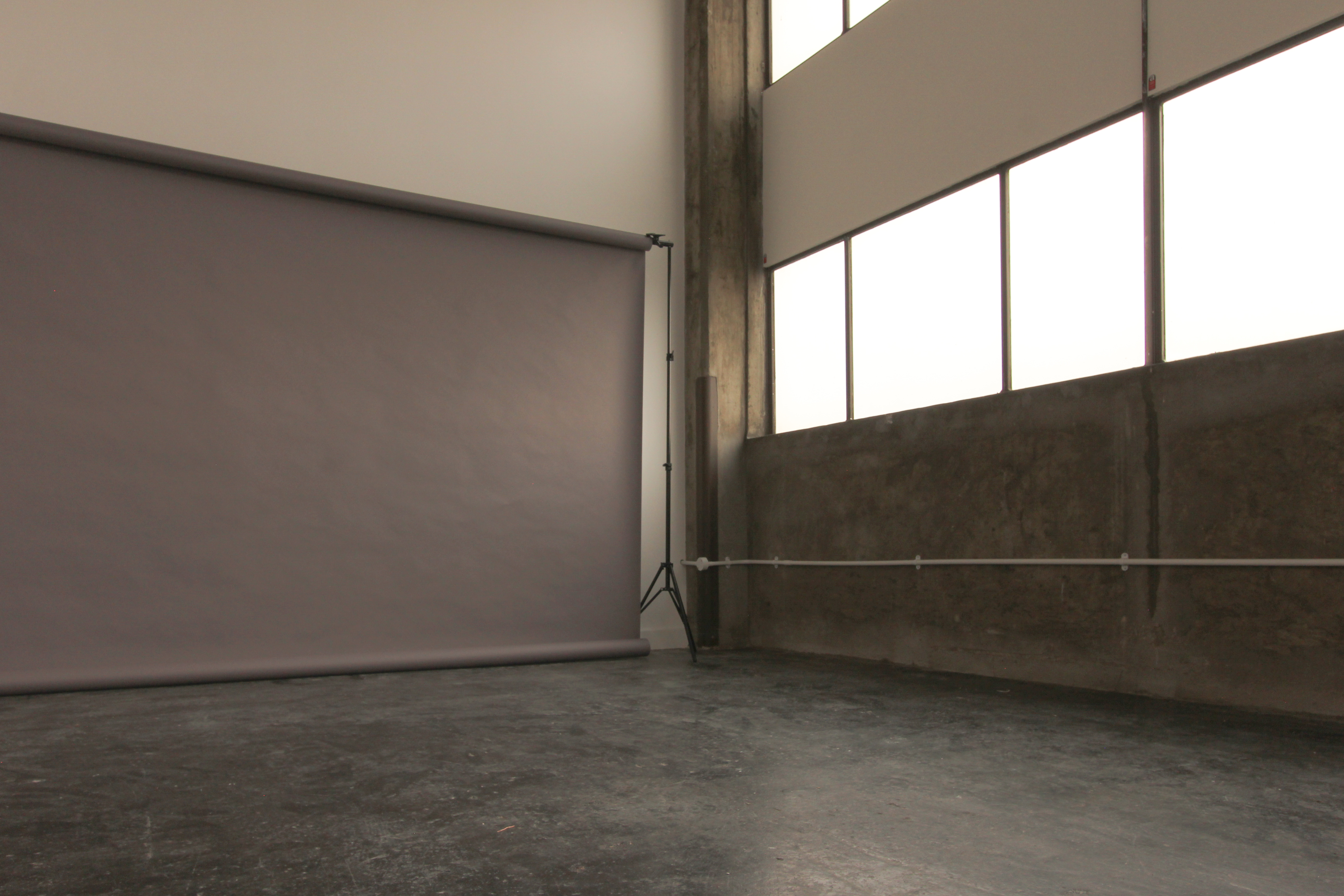 Versatile event space in Aseptic Studios with natural light, perfect for workshops and presentations.