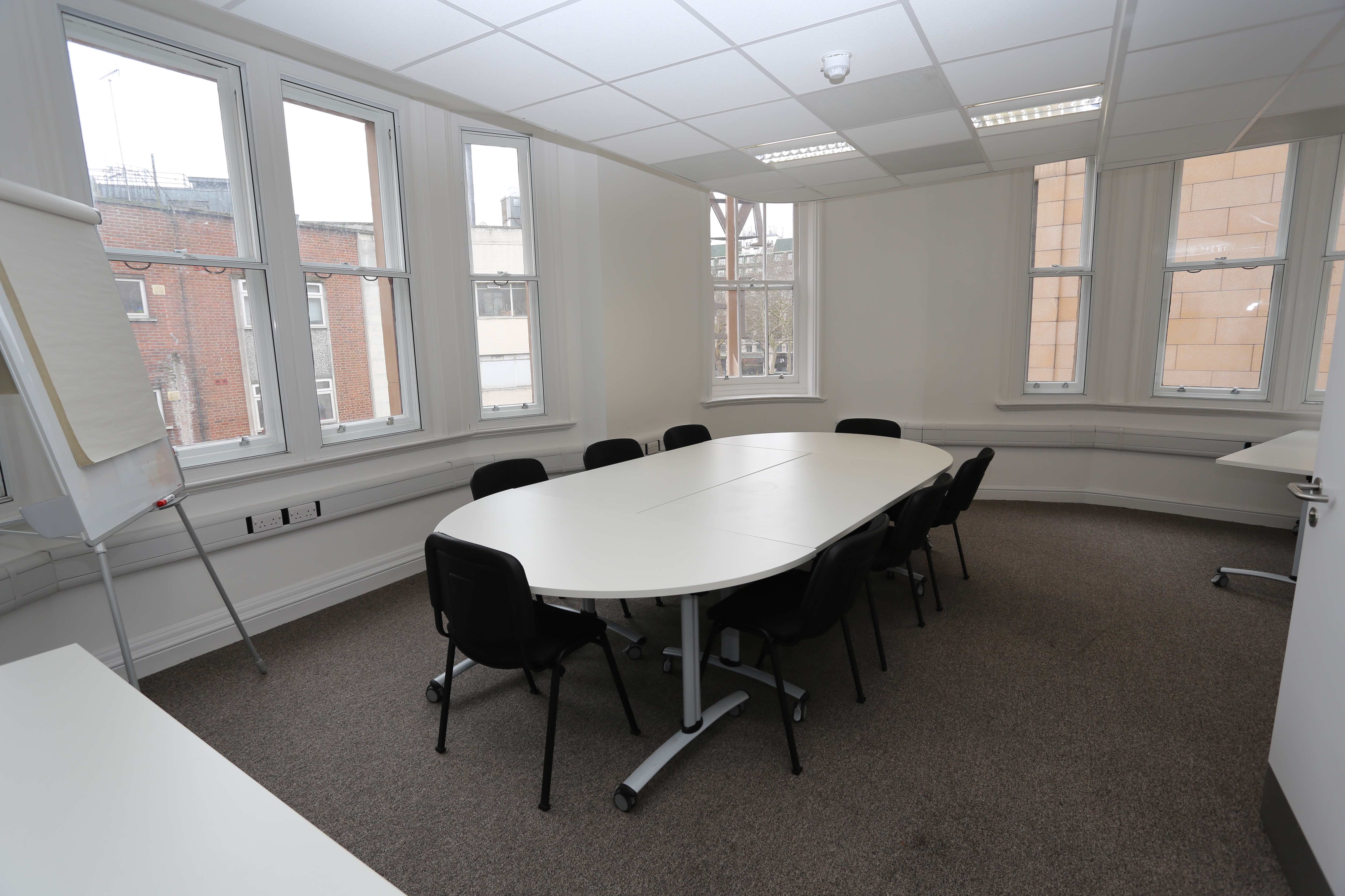 Main hall in Chinese Community Centre, oval table, ideal for meetings and presentations.