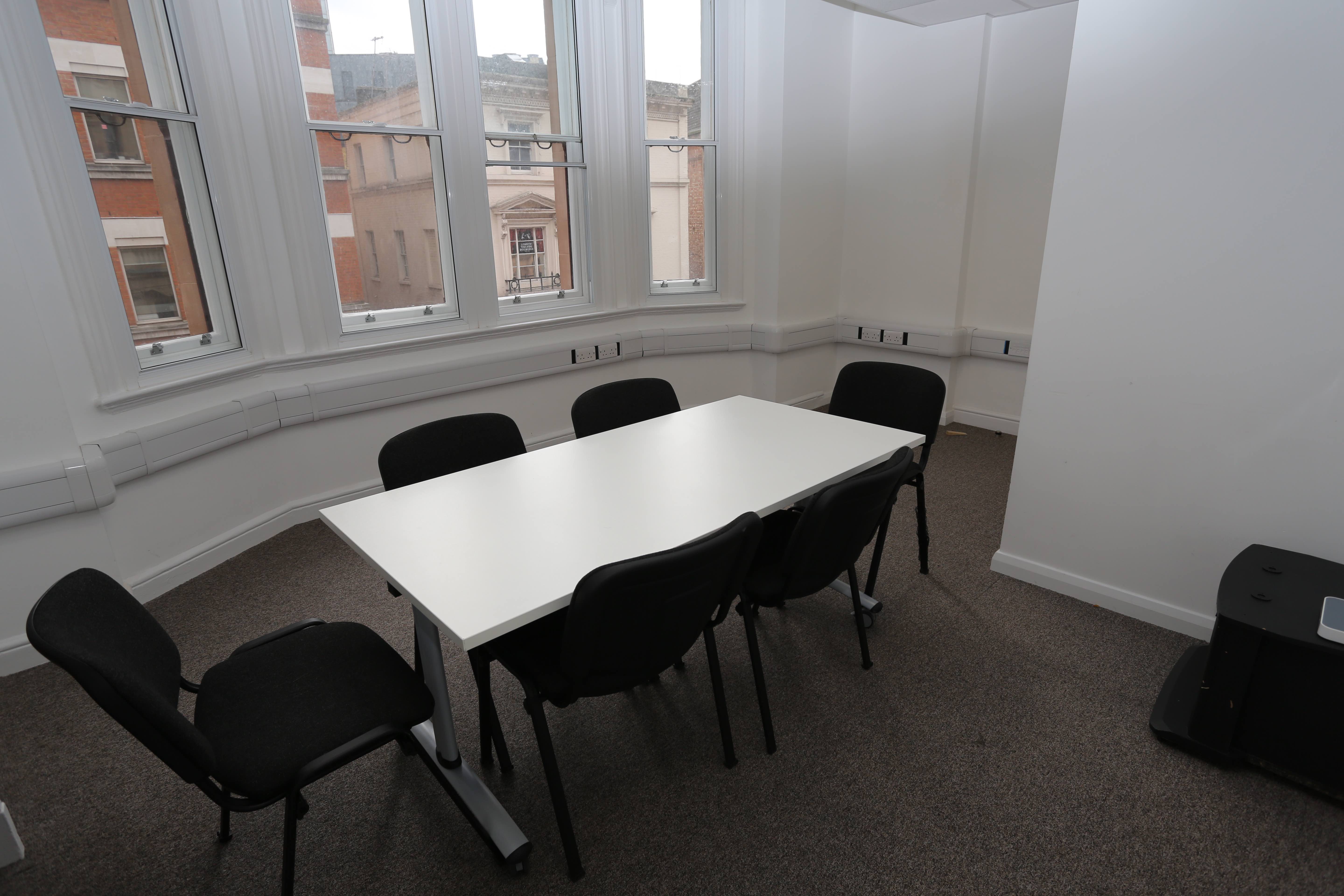 Main hall in Chinese Community Centre with a rectangular table for meetings.