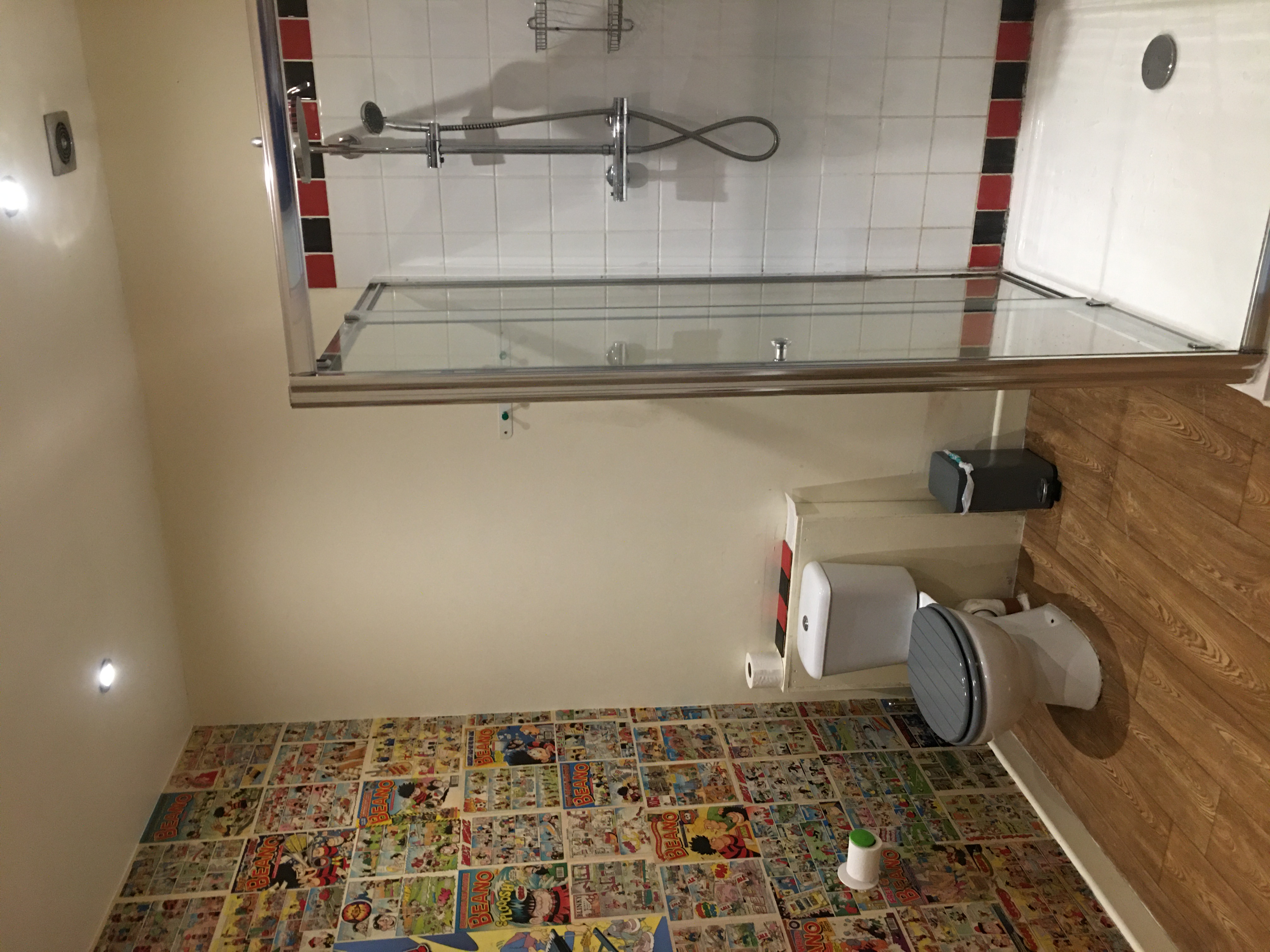 Koa tree restroom with vibrant comic book wall, enhancing event experience.