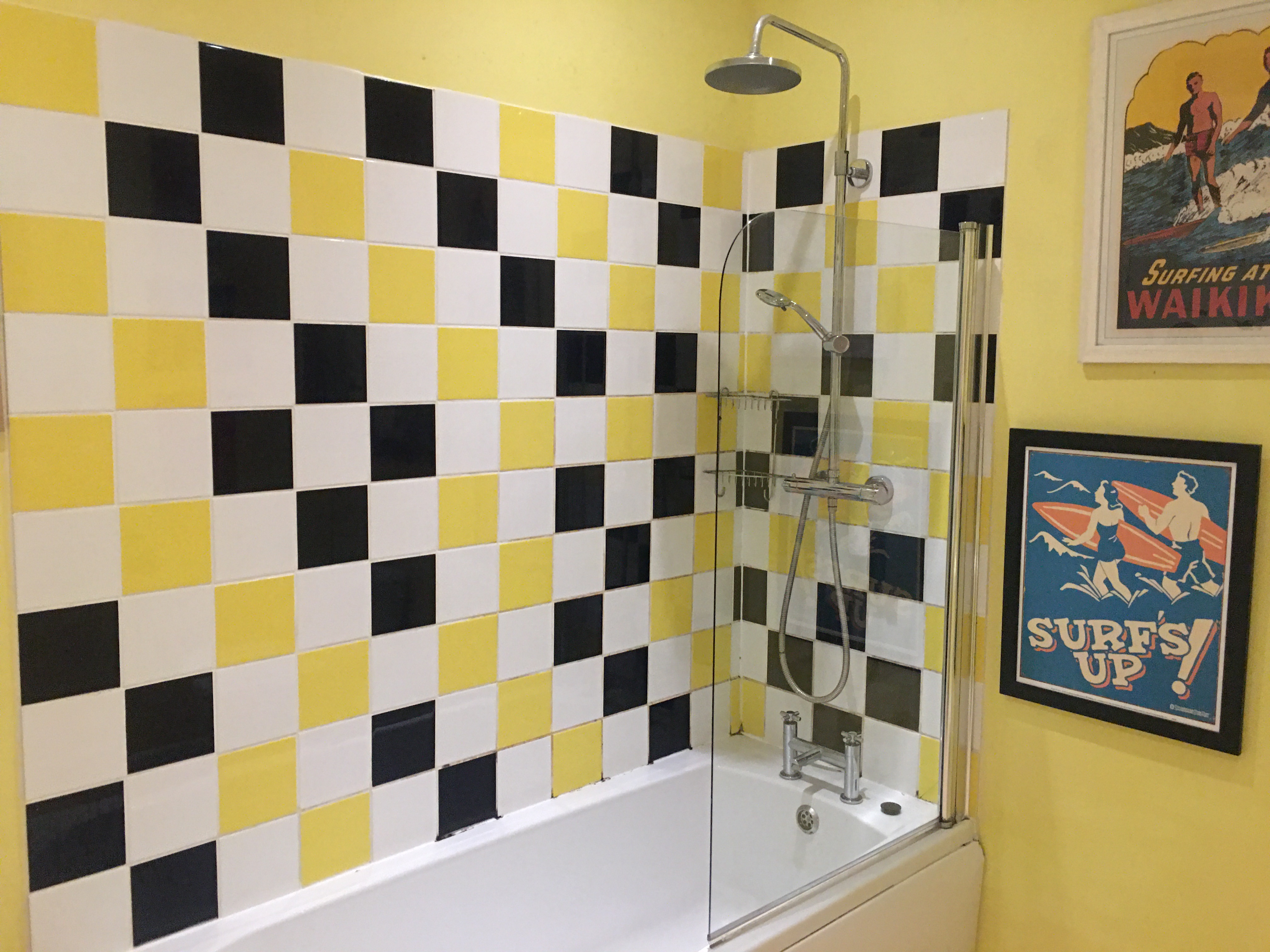 Vibrant bathroom with black and yellow tiles, ideal for unique event branding.