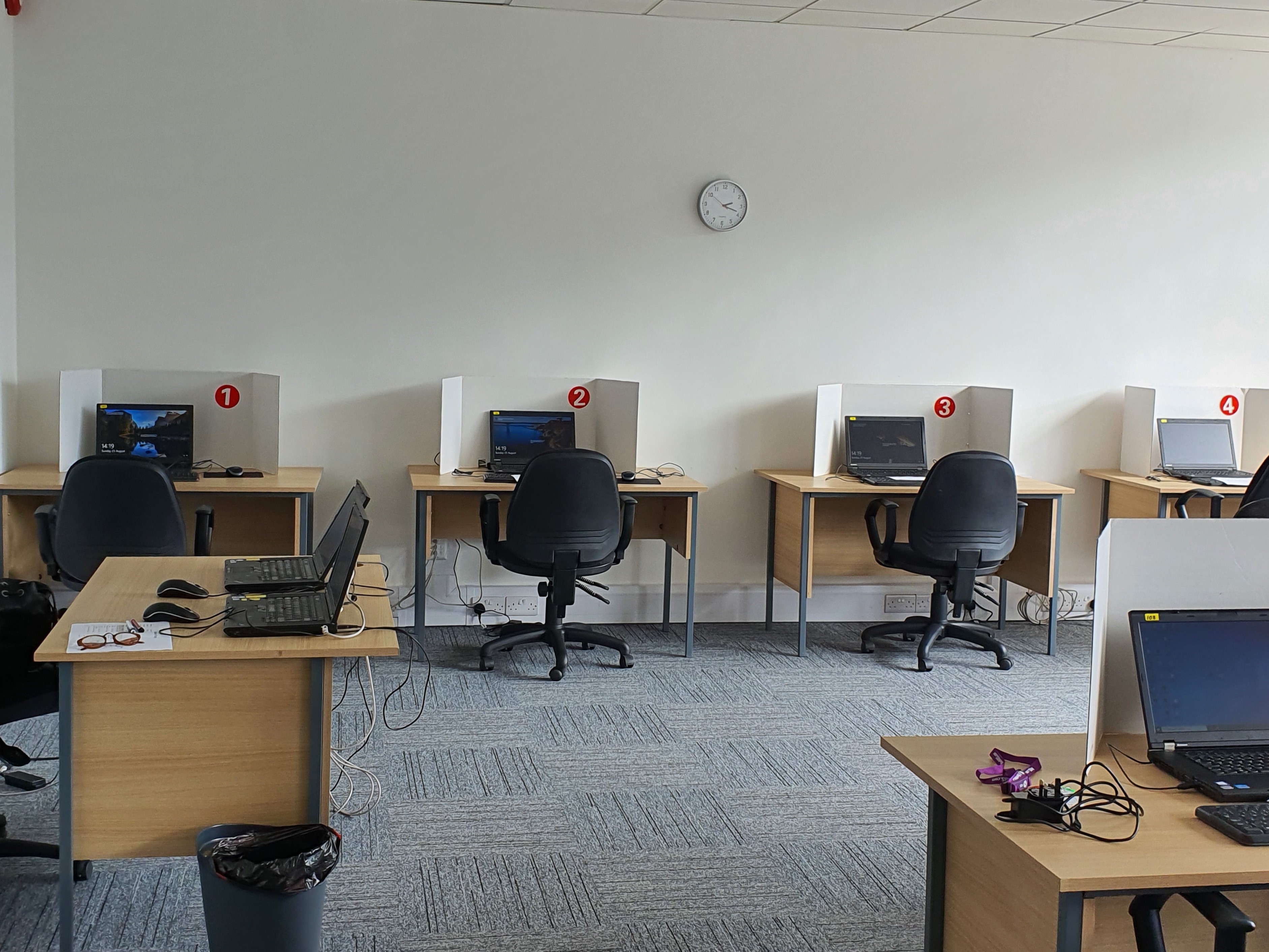 Minimalist exam room with individual workstations for training and remote collaboration.