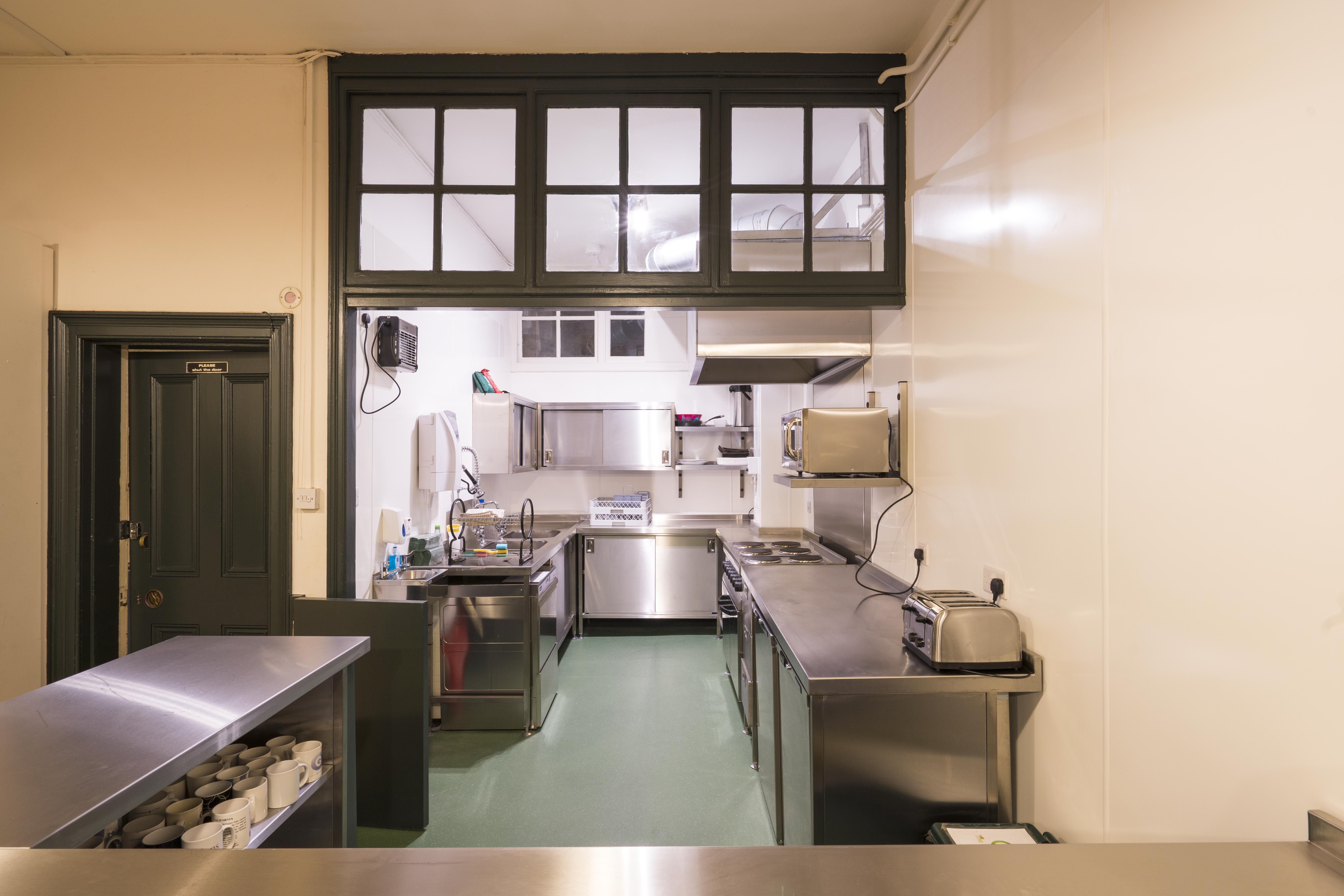 Commercial kitchen in Unity Islington, stainless steel surfaces, catering events setup.