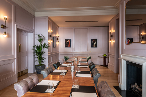 Sophisticated meeting room with elegant decor for intimate gatherings and dinner meetings.