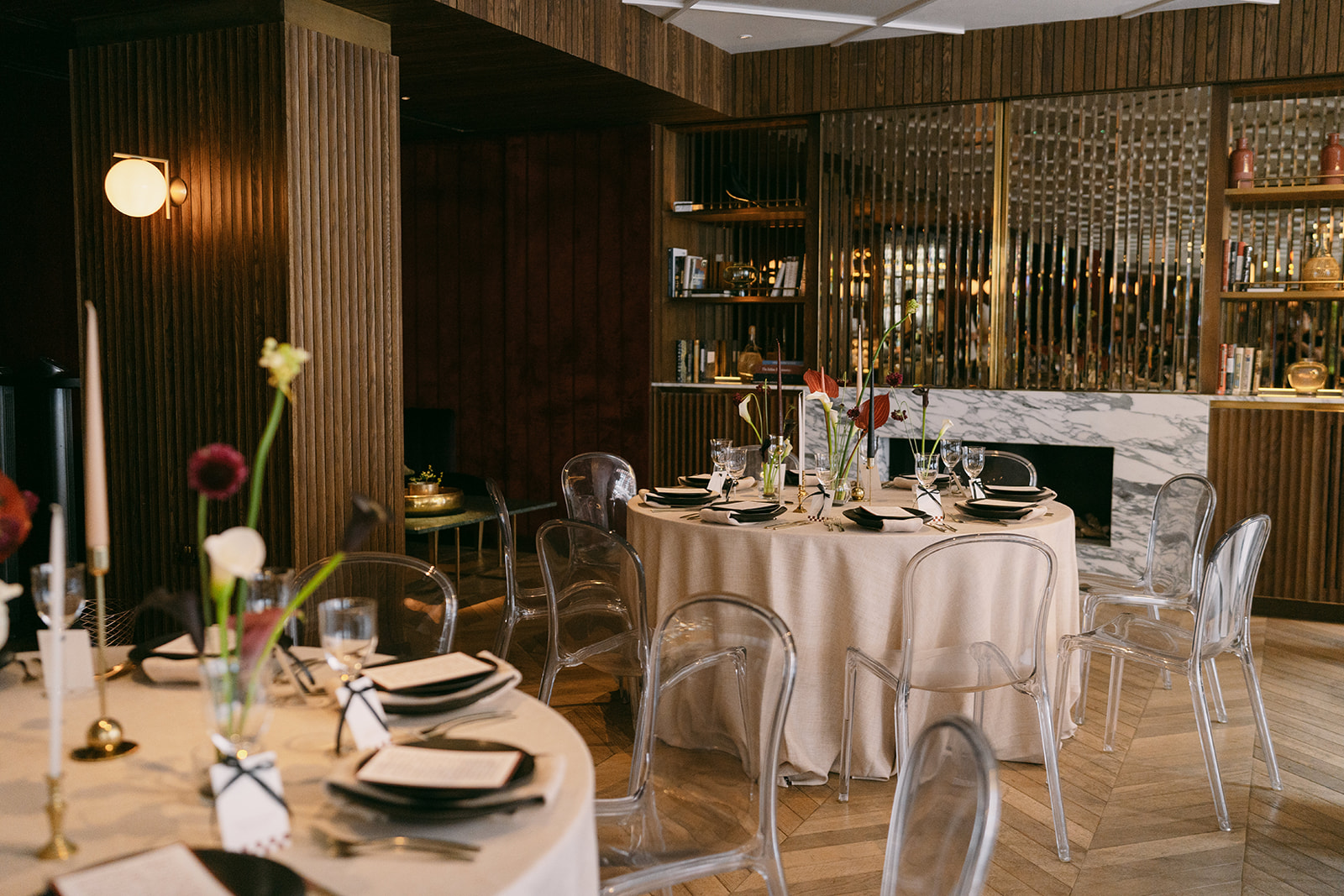 Elegant dining space at Number Six, featuring round tables and modern acrylic chairs for upscale events.