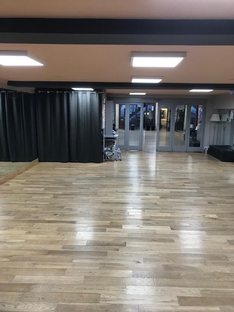 Versatile event space with polished wooden floors for workshops and gatherings.