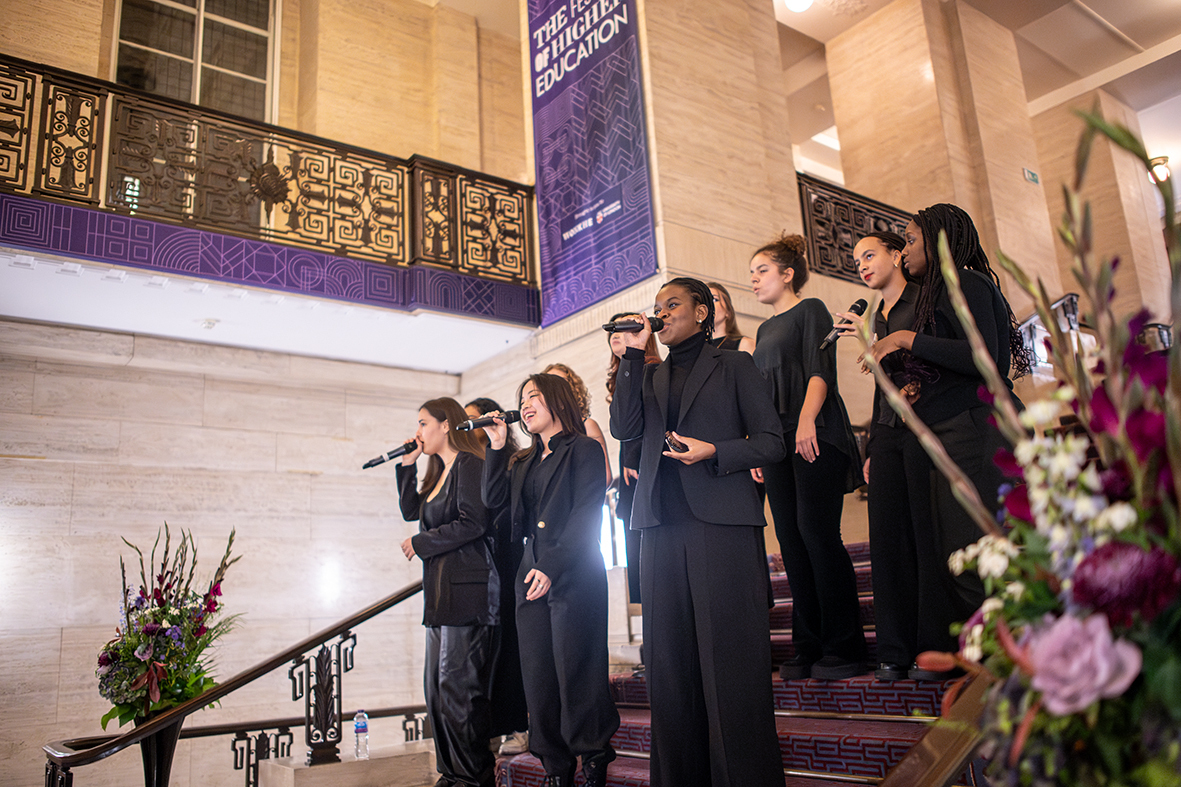 Performers on staircase at Crush Hall, University of London, enhancing upscale event ambiance.
