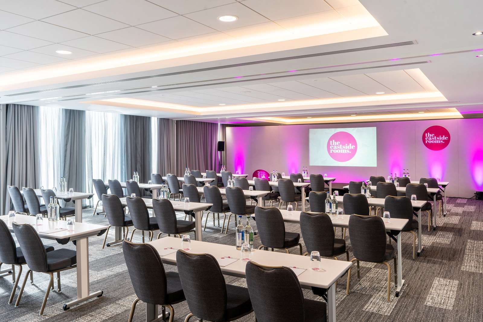 Belmont Suite meeting space with modern furnishings, ideal for corporate events and workshops.