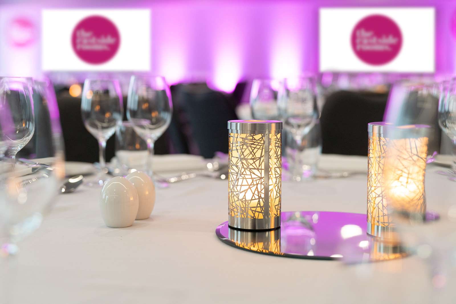 Belmont Suite dining table with elegant candle holders for upscale events.