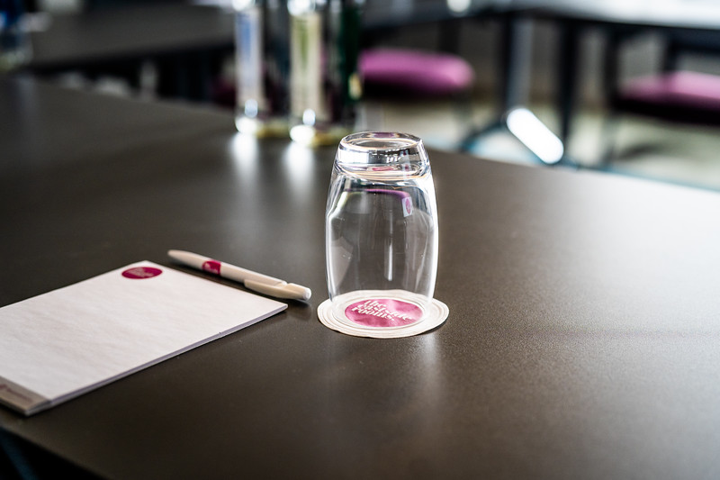 Meeting Room Eight setup with notepad, pen, and glass for professional meetings.