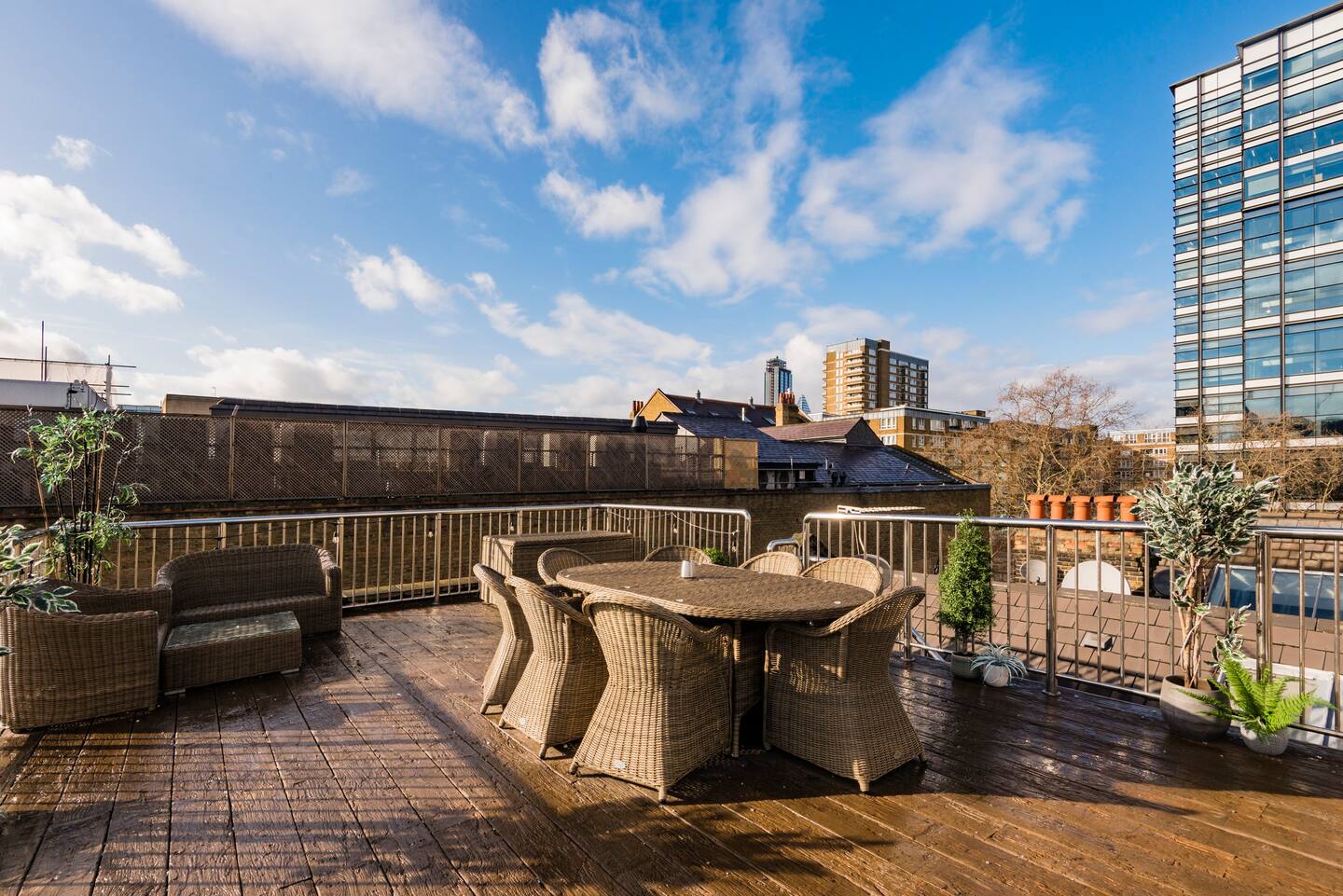 Spacious rooftop terrace in Shoreditch for events, featuring stylish wicker furniture.