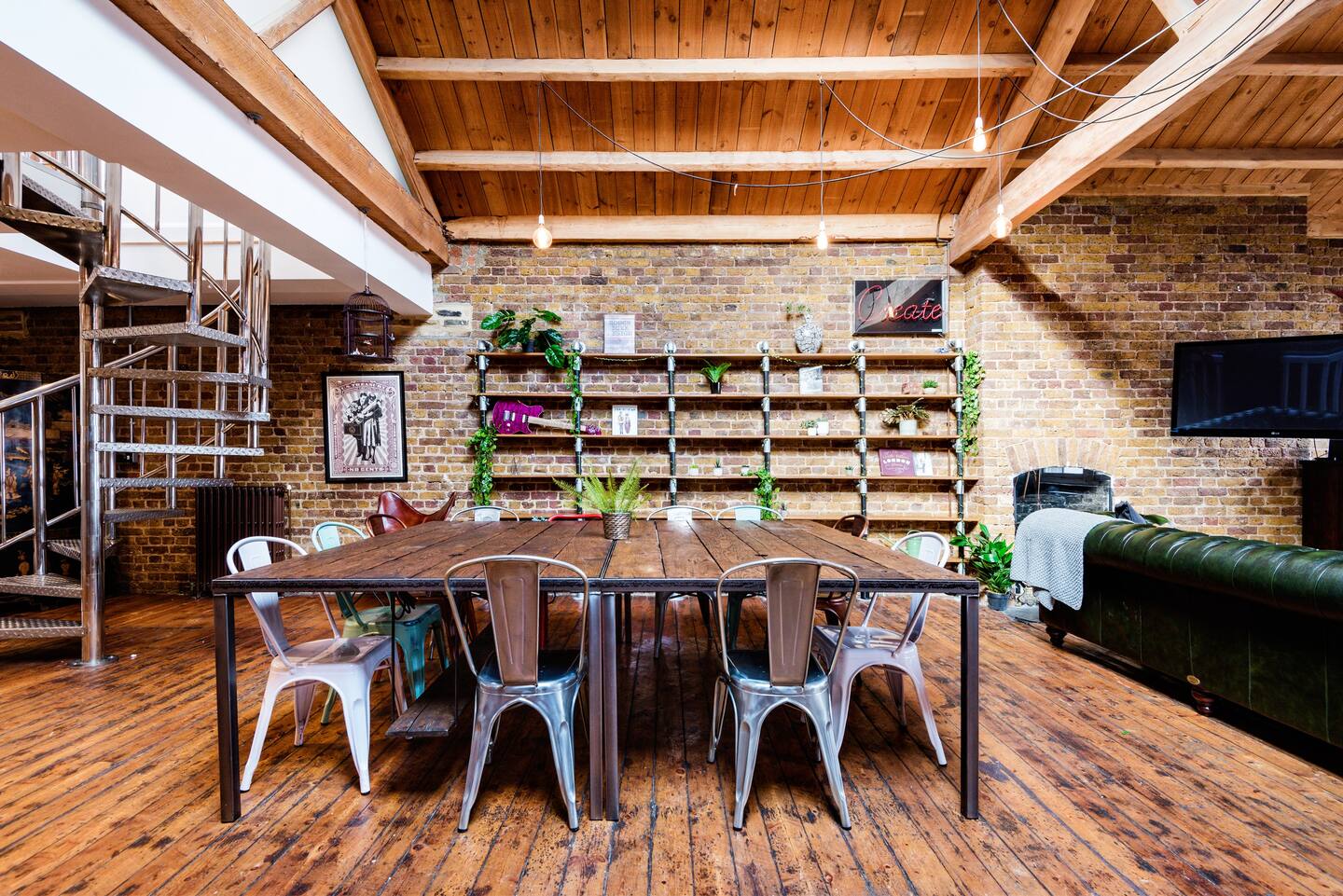 Stylish Shoreditch apartment meeting space with wooden table and roof terrace views.