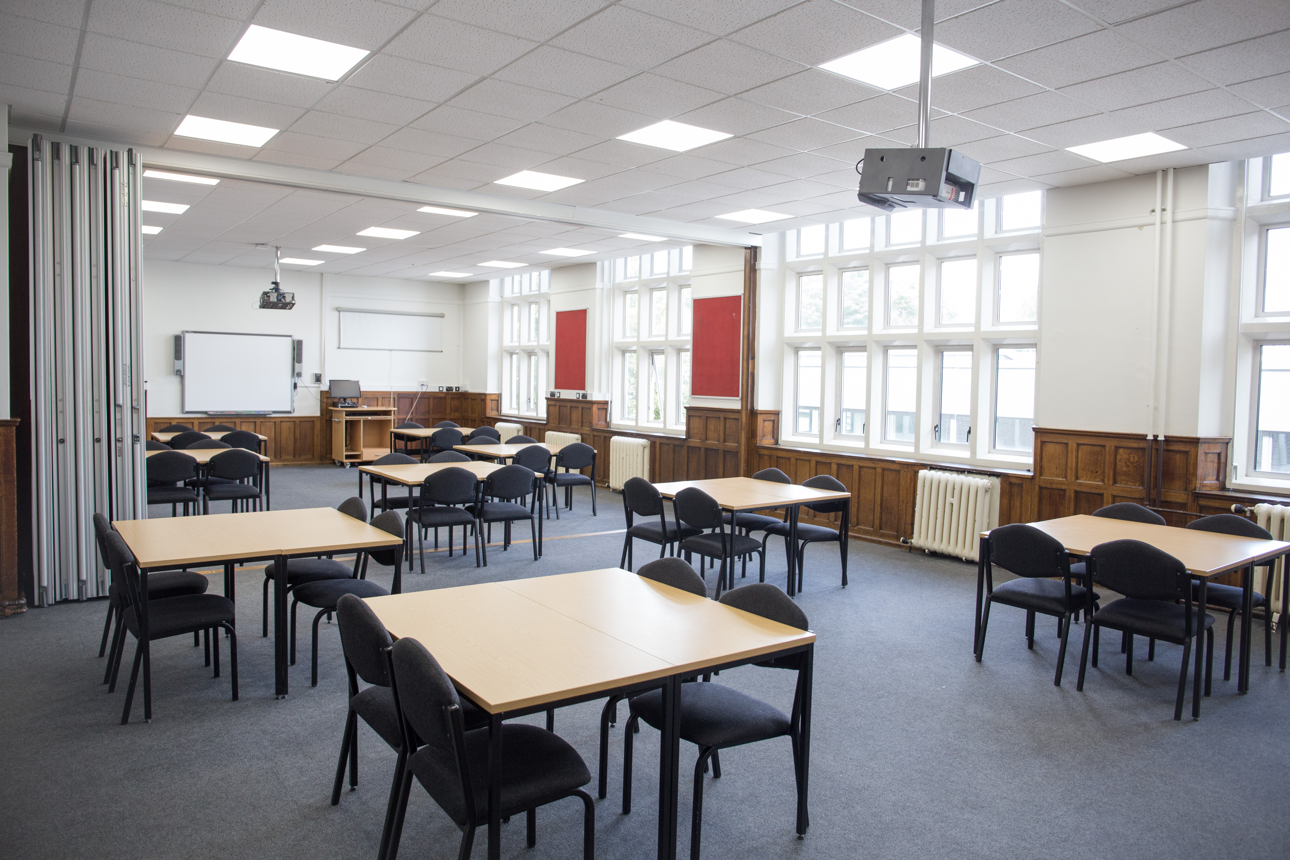 Versatile Chesterfield College classroom with natural light, ideal for workshops and meetings.