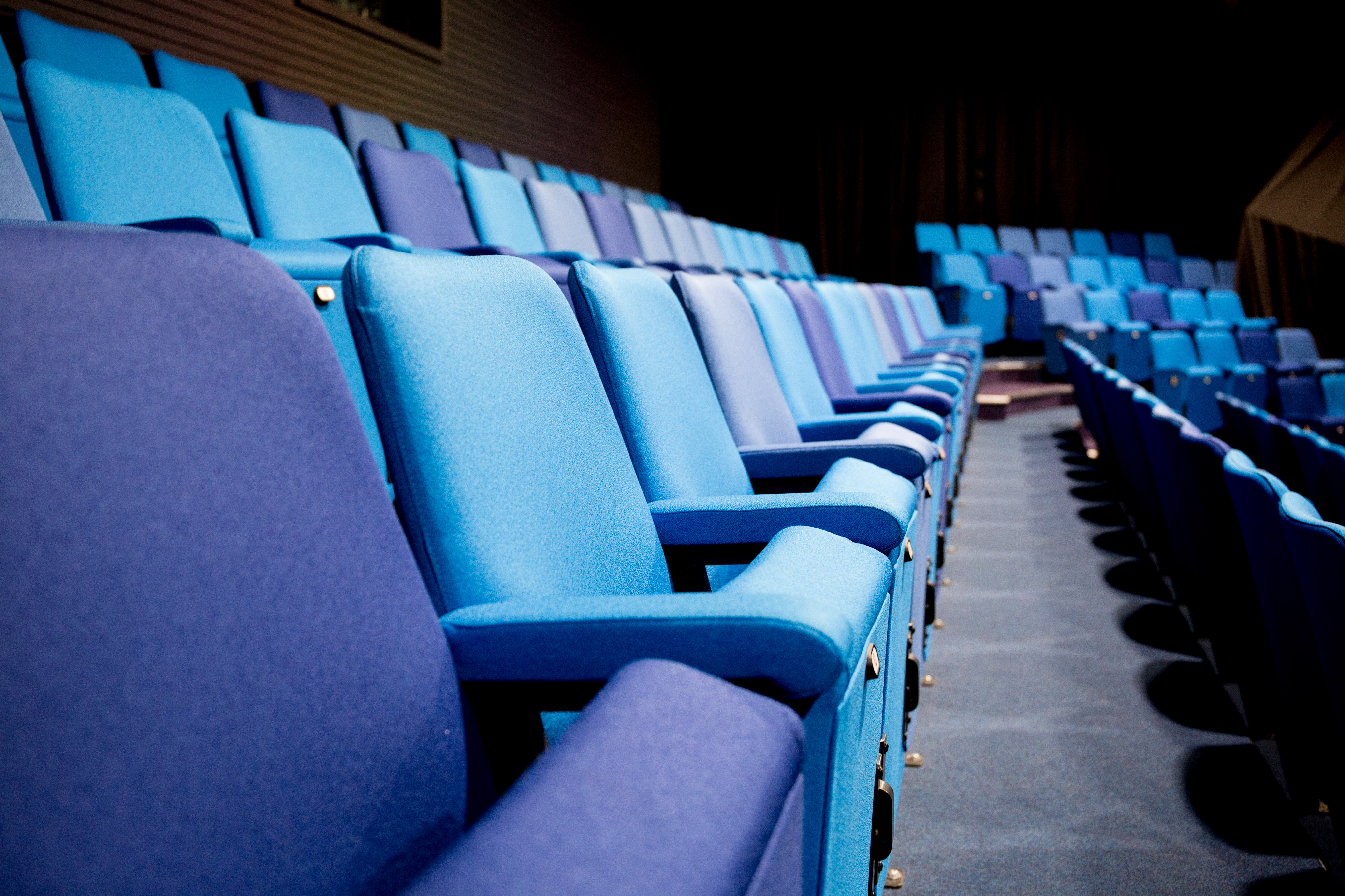 Chesterfield College Theatre seating area with blue tones for engaging events and presentations.