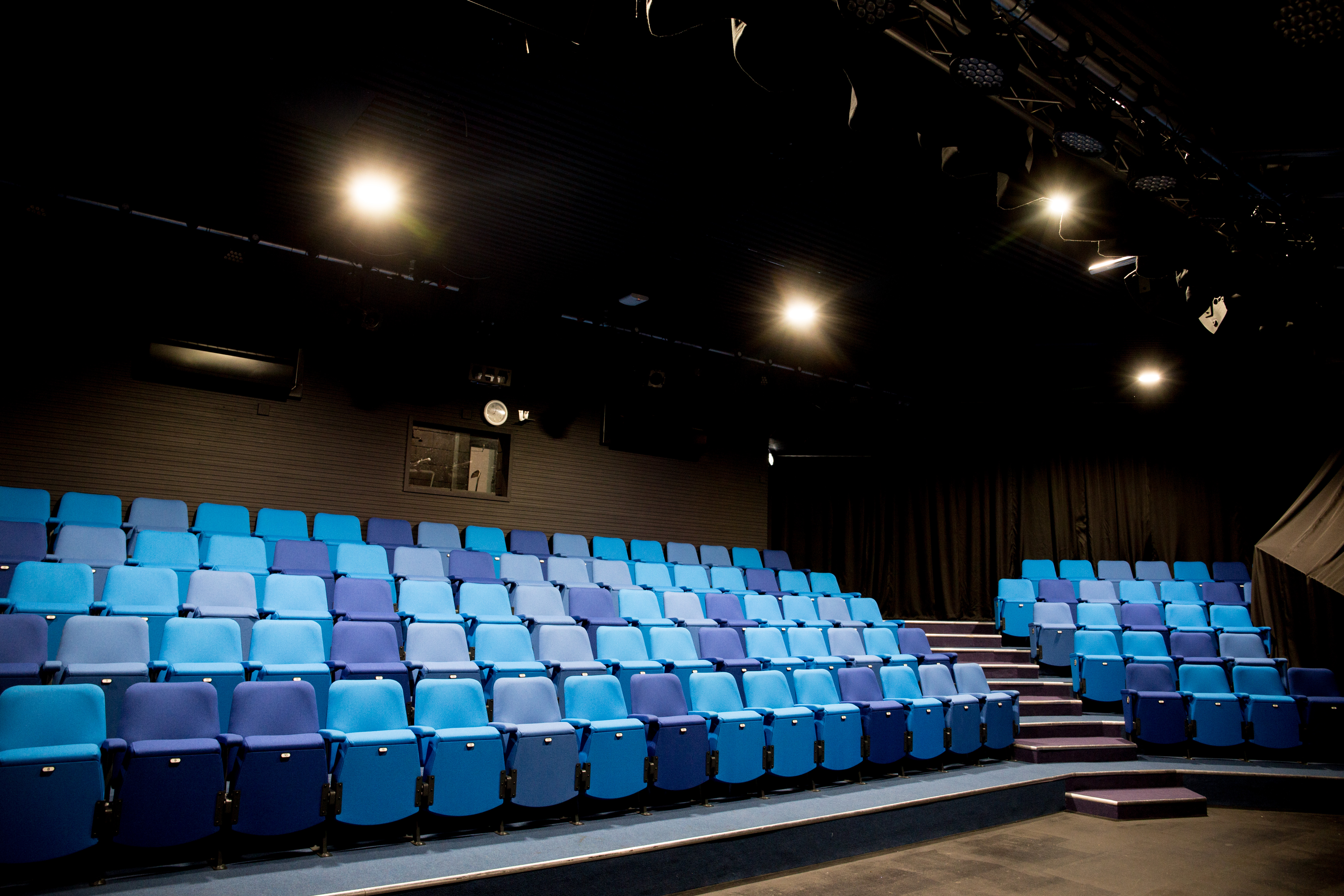 Chesterfield College theater with tiered blue seating for performances and workshops.