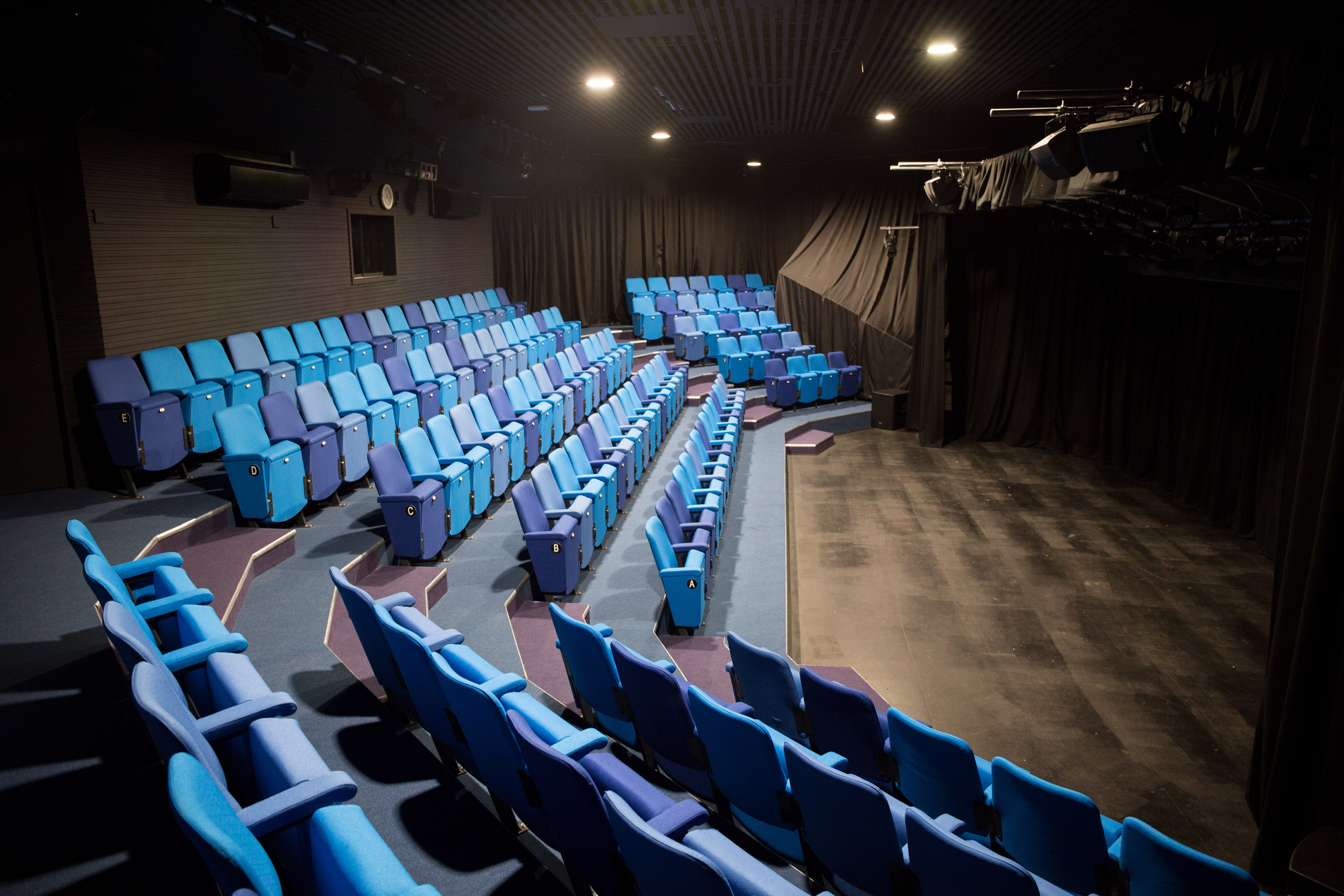 Chesterfield College theater with tiered blue seating for presentations and performances.