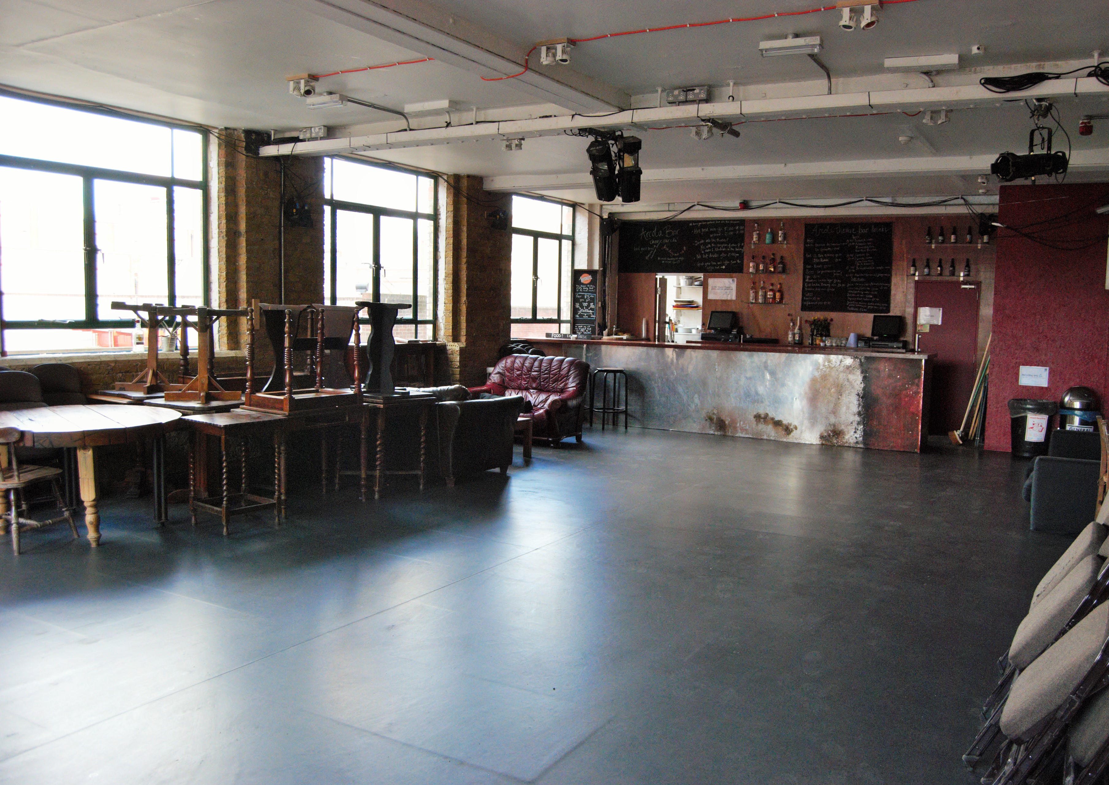 Versatile event space at Arcola Theatre & Bar with natural light, ideal for gatherings.