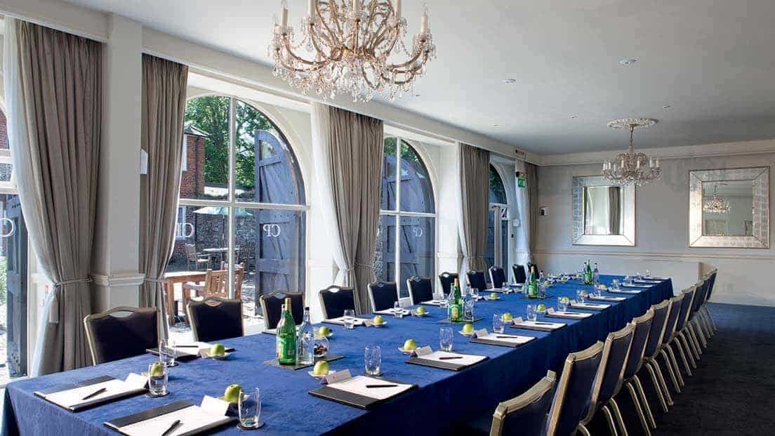 Elegant meeting room at Chilston Park Hotel with natural light and sophisticated decor.