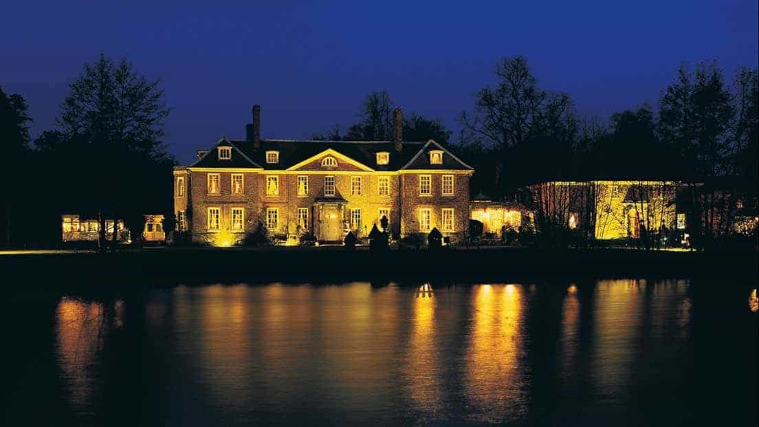 Elegant Coach House at Chilston Park Hotel by serene lake, perfect for weddings and events.