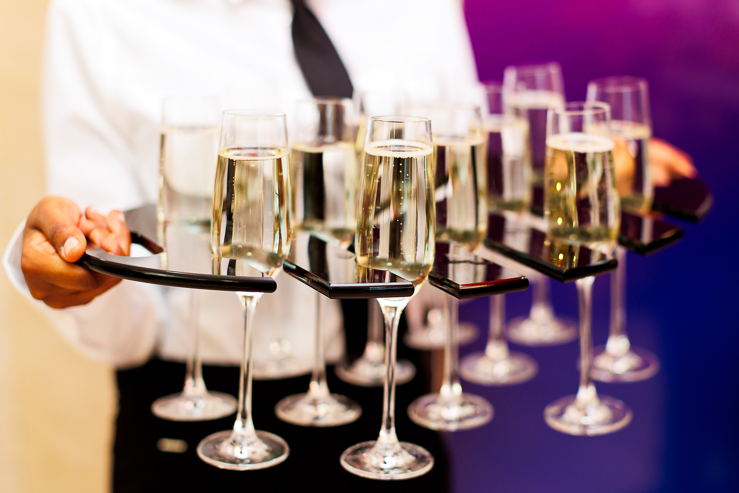 Elegant server presenting champagne flutes at Beveridge Hall, perfect for receptions and events.