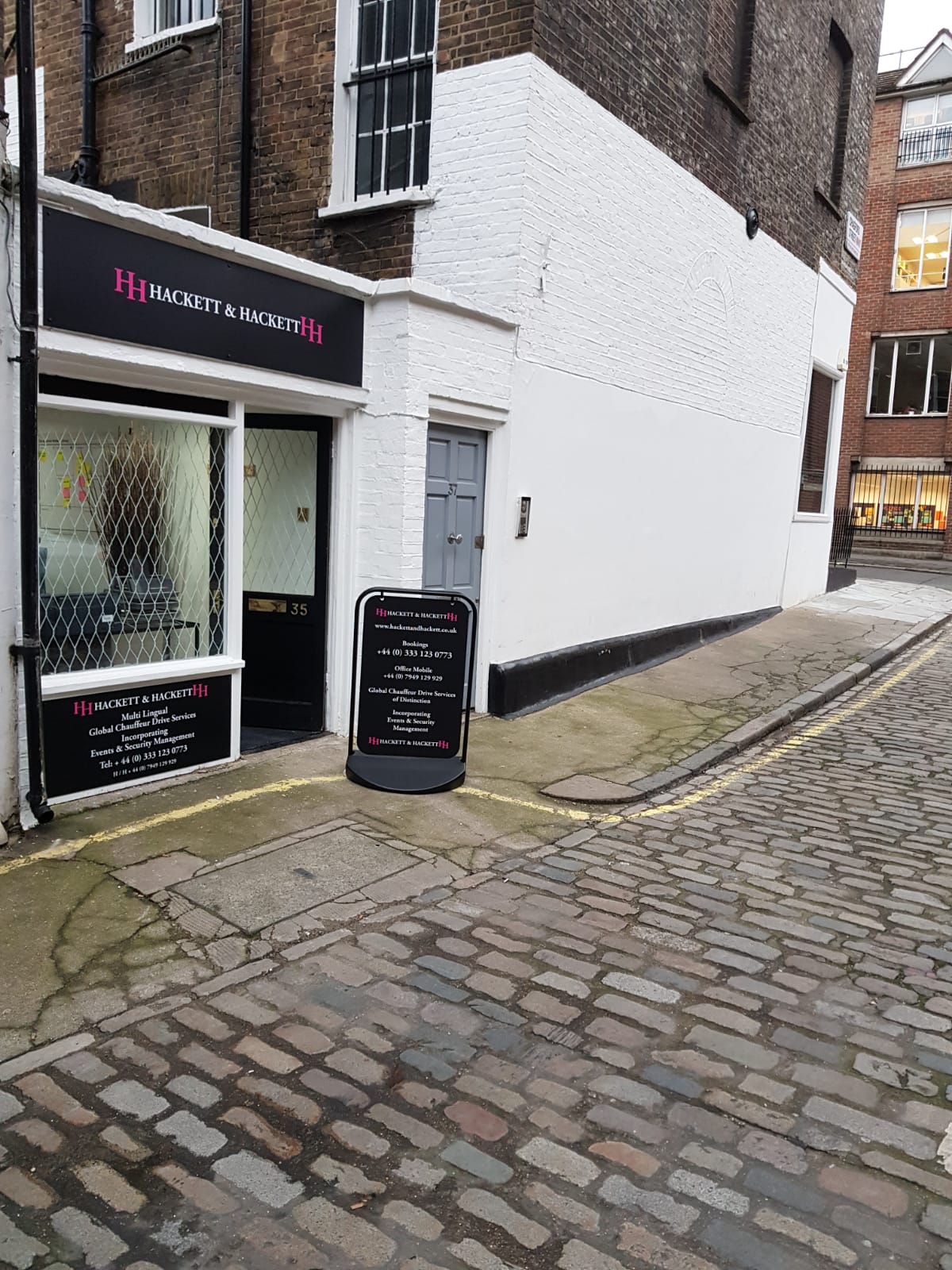 Quaint venue entrance on cobblestone street for intimate meetings and workshops.