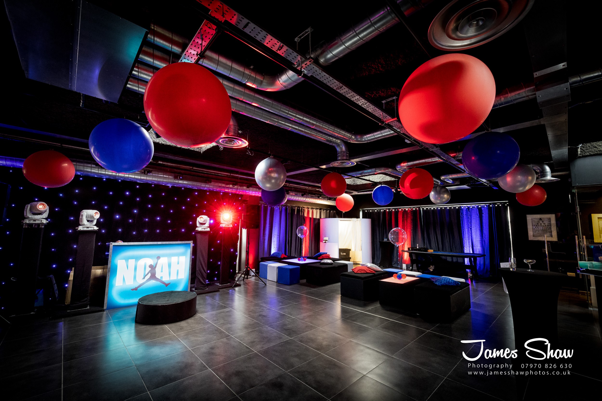 V12 Room event space with bold red and blue decor for corporate gatherings.