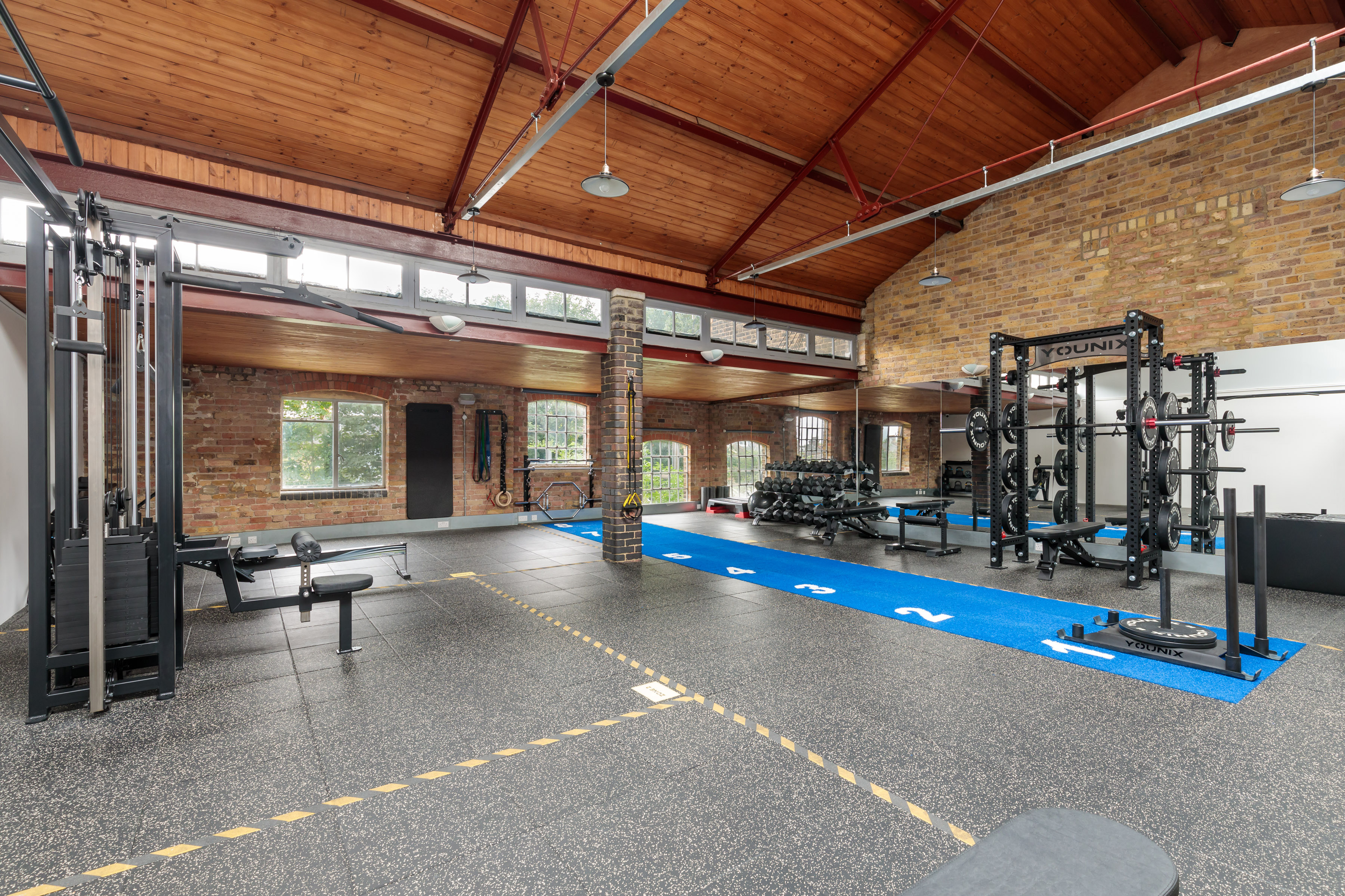 Spacious gym venue with natural light for fitness events and wellness retreats.